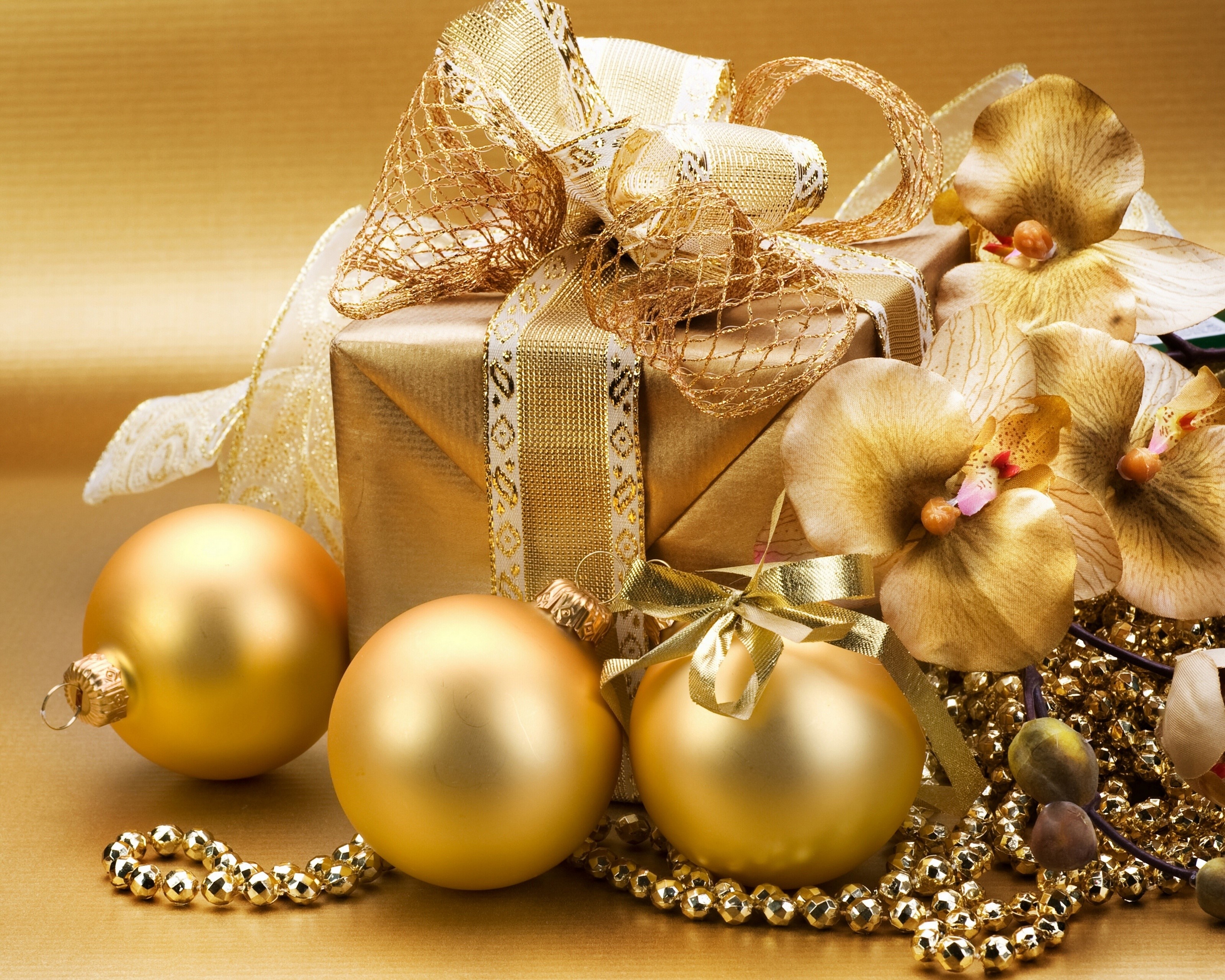 Golden Christmas gift with ornaments and orchids HD Wallpaper