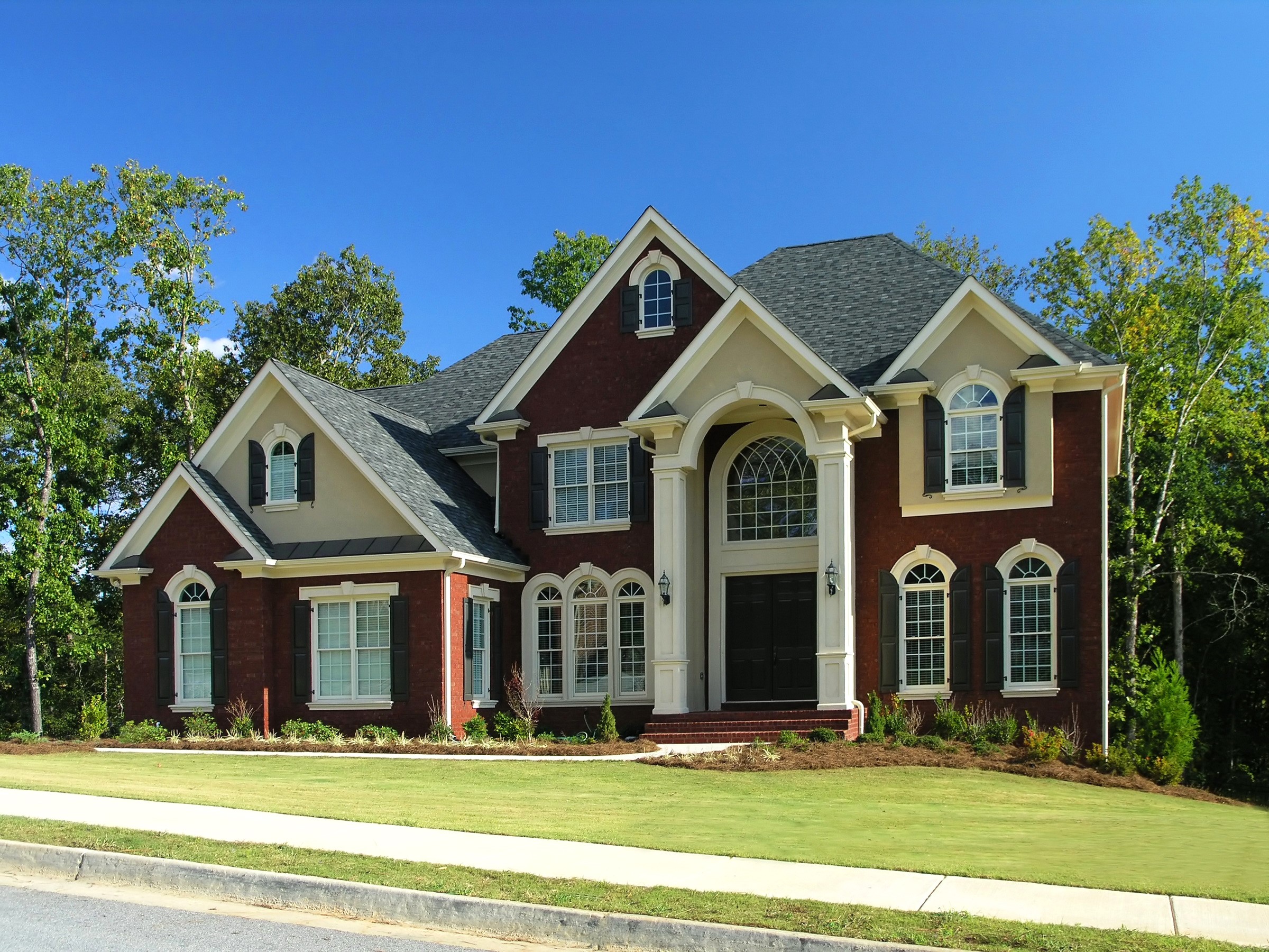 Brick and beige luxury house with manicured lawn HD Wallpaper