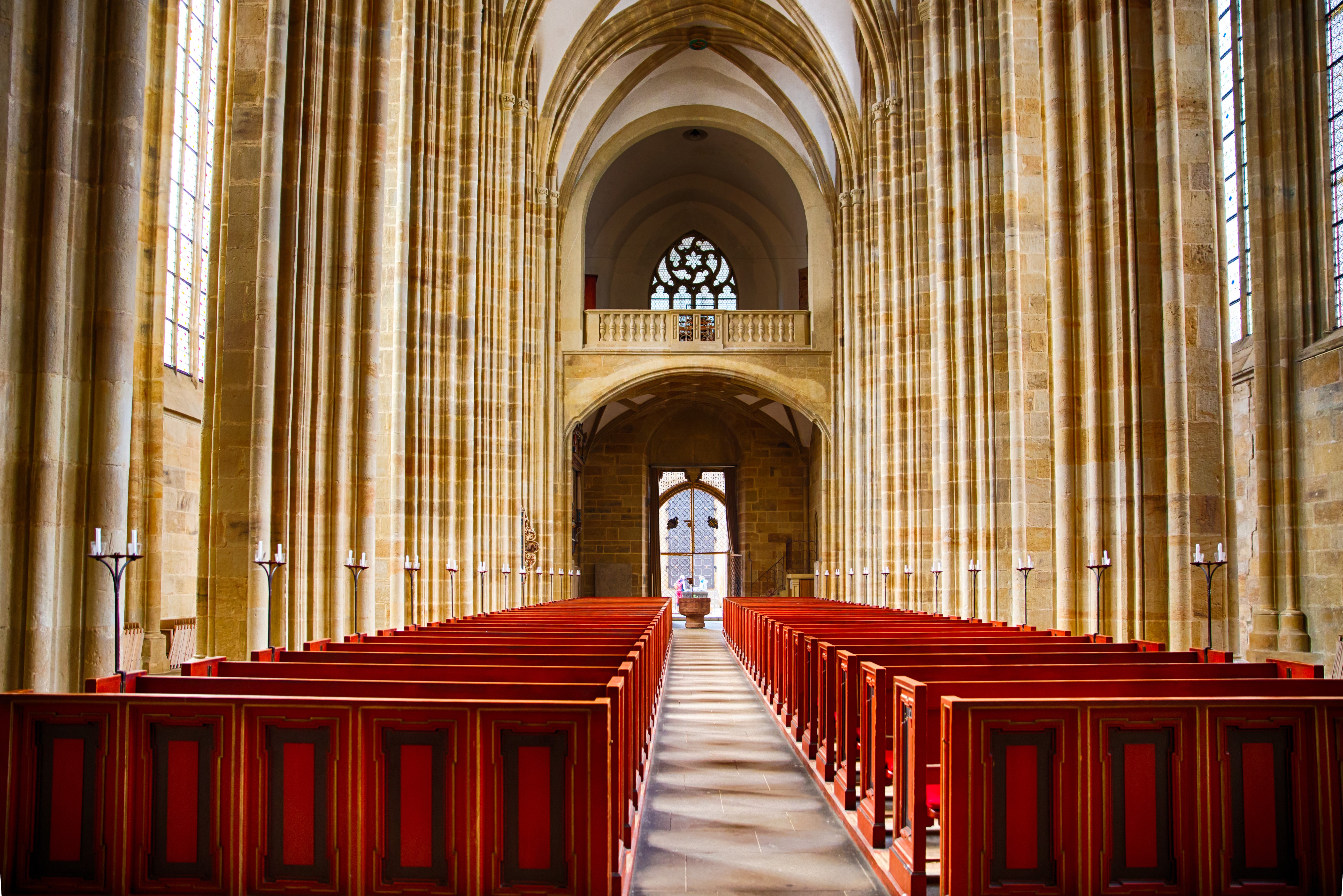 Interior of a large church with rows of pews HD Wallpaper