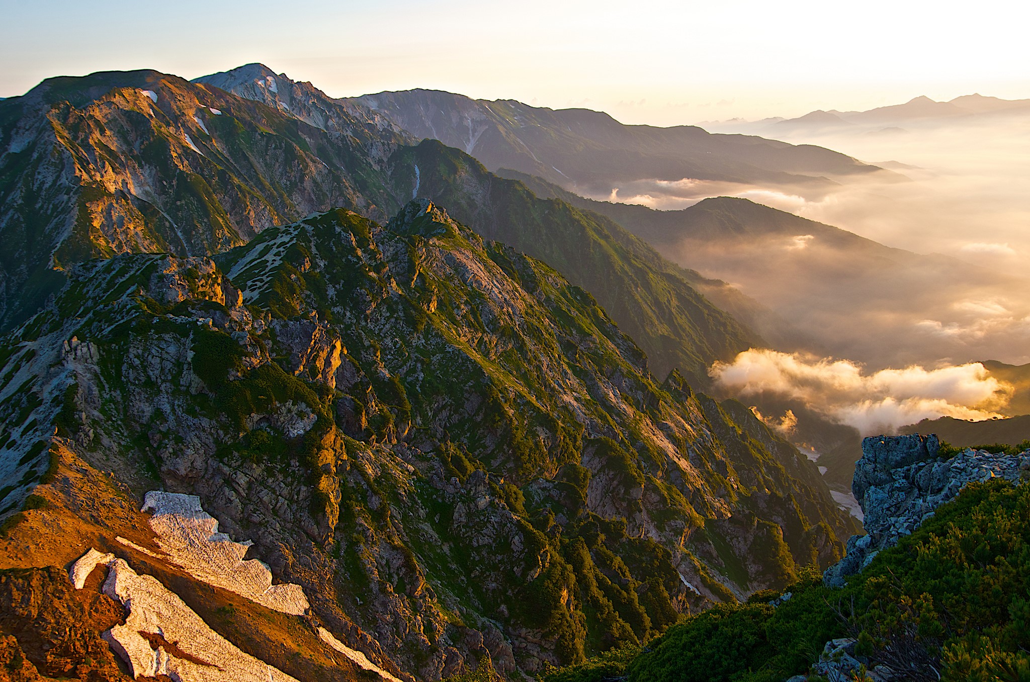 Mountain range with clouds at sunrise HD Wallpaper