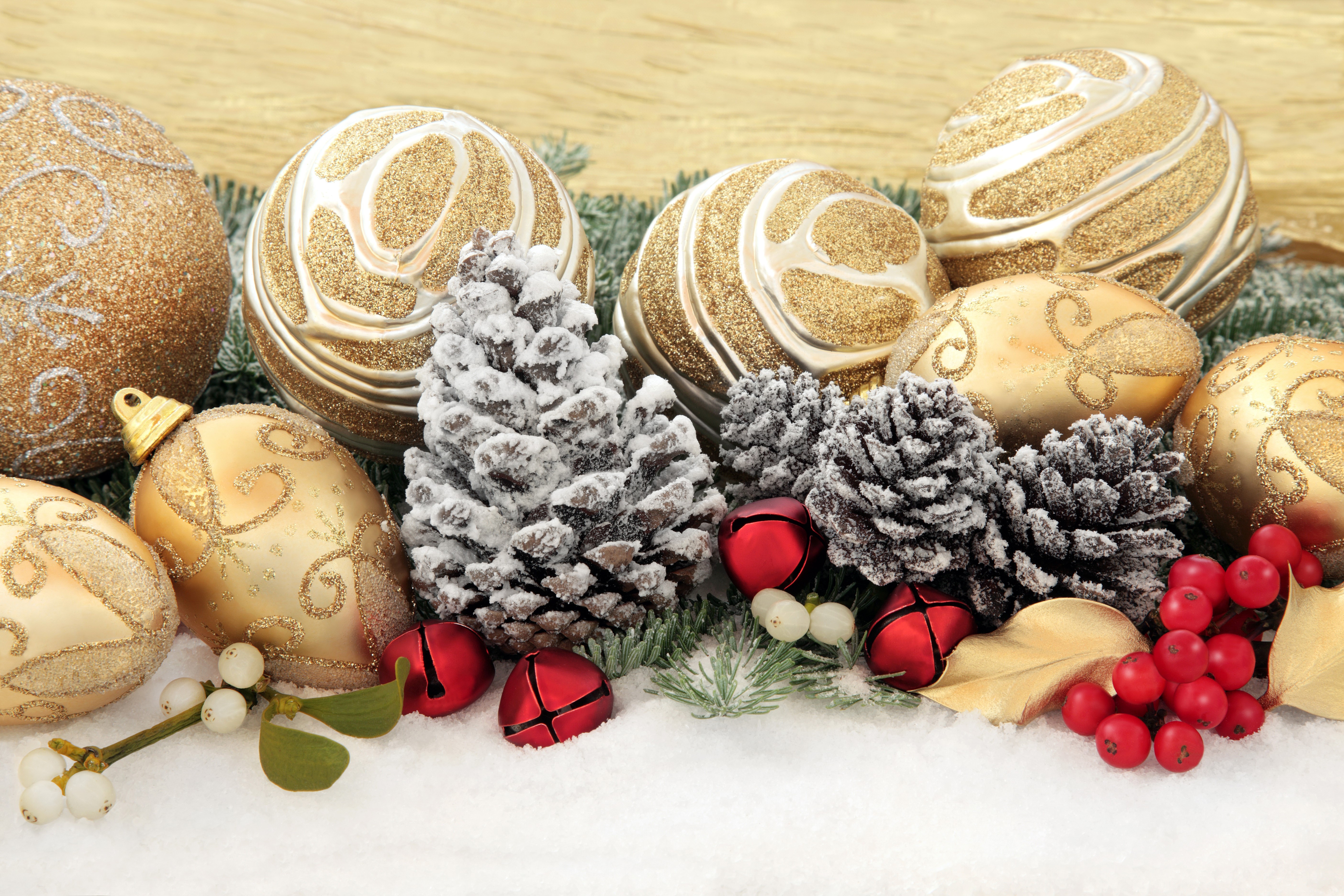 Christmas ornaments, pine cones, and berries on snow HD Wallpaper
