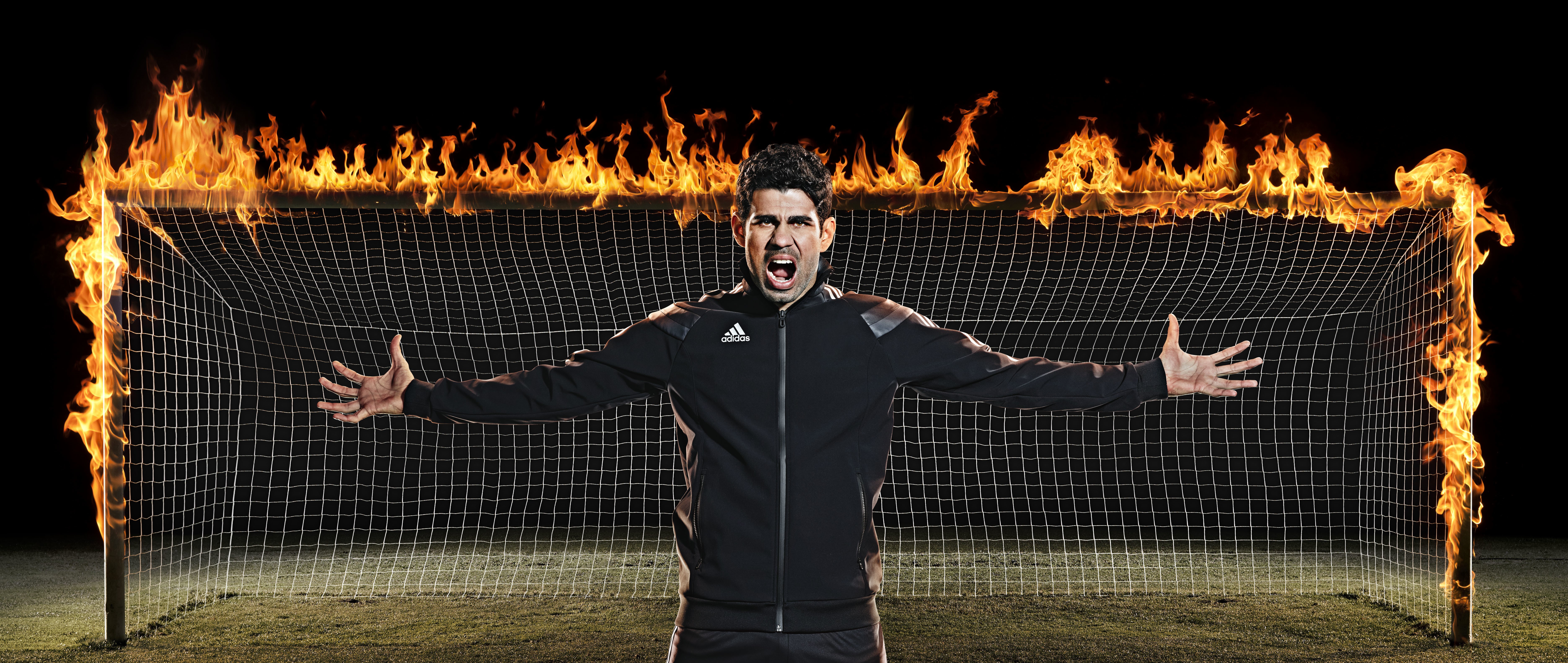 Diego Costa in front of a burning soccer goal HD Wallpaper