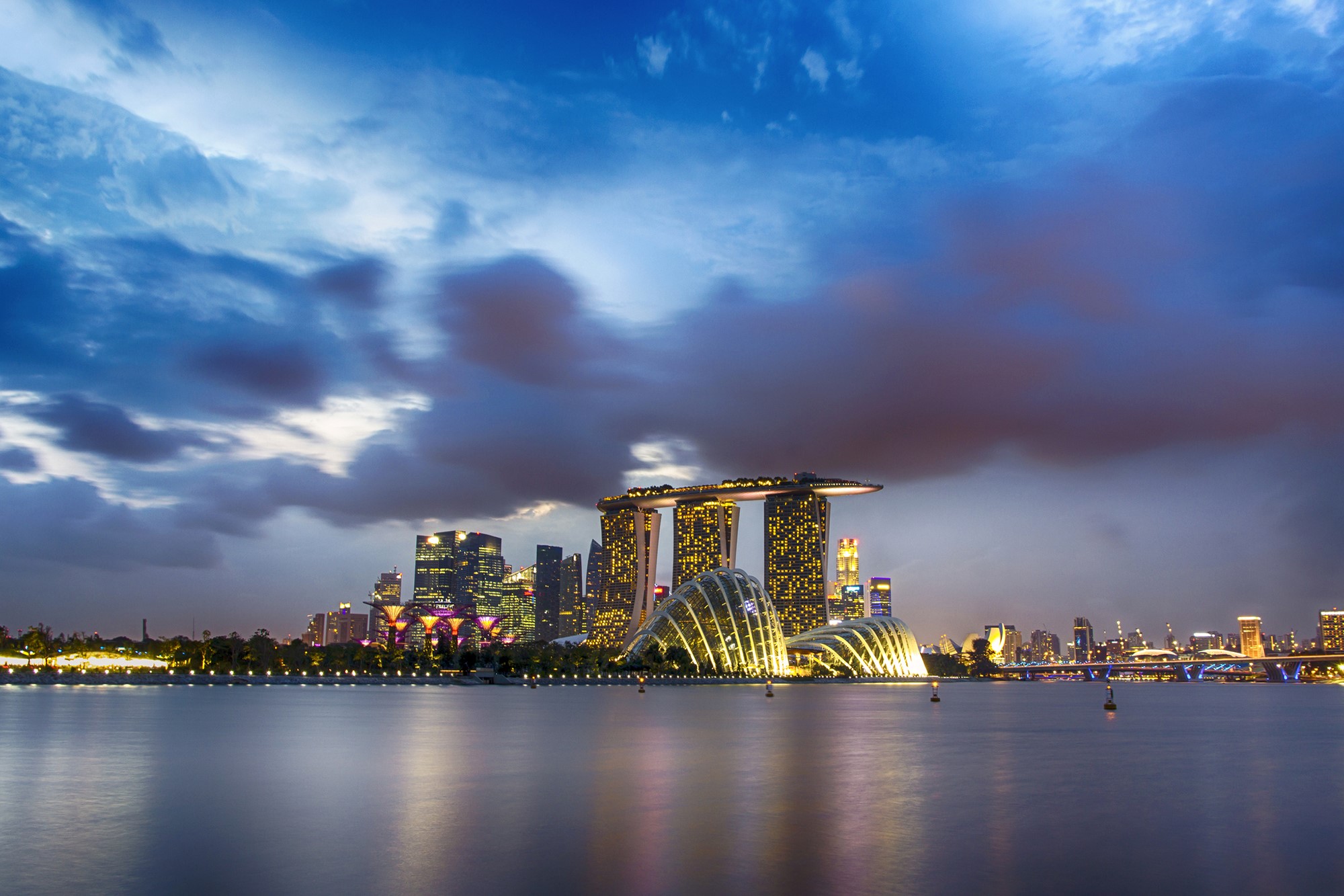 Singapore skyline with Marina Bay Sands and Gardens by the Bay at dusk HD Wallpaper