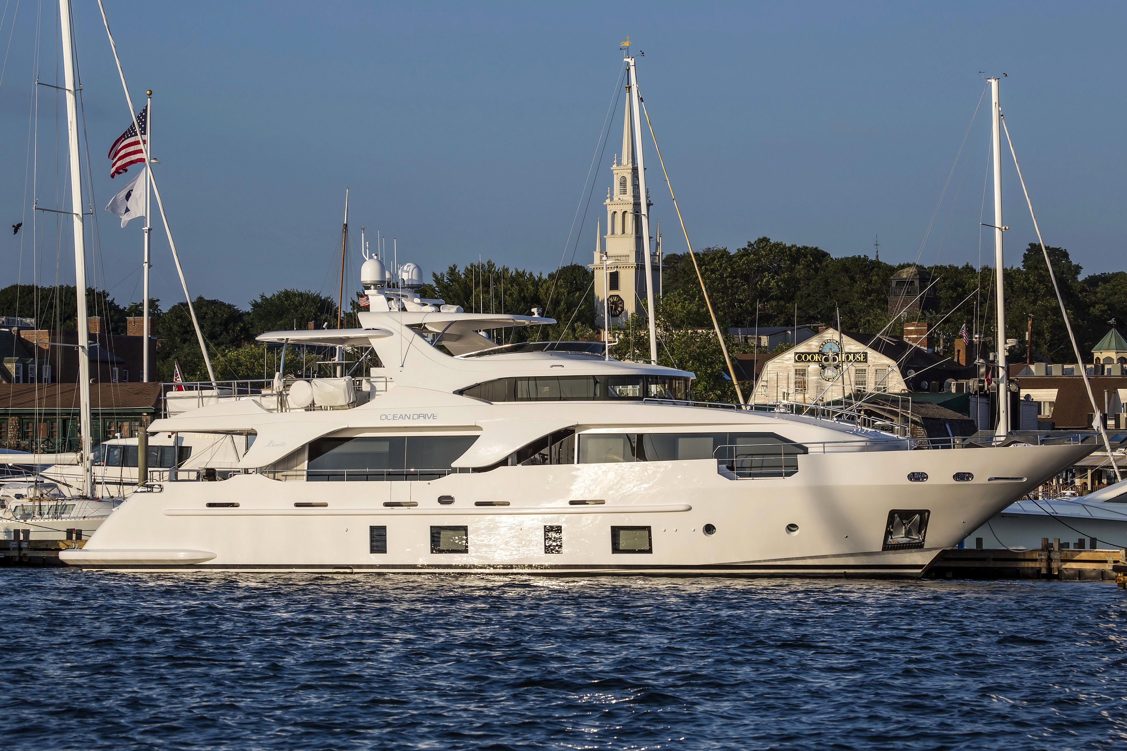 White yacht named Ocean Drive docked in a harbor HD Wallpaper