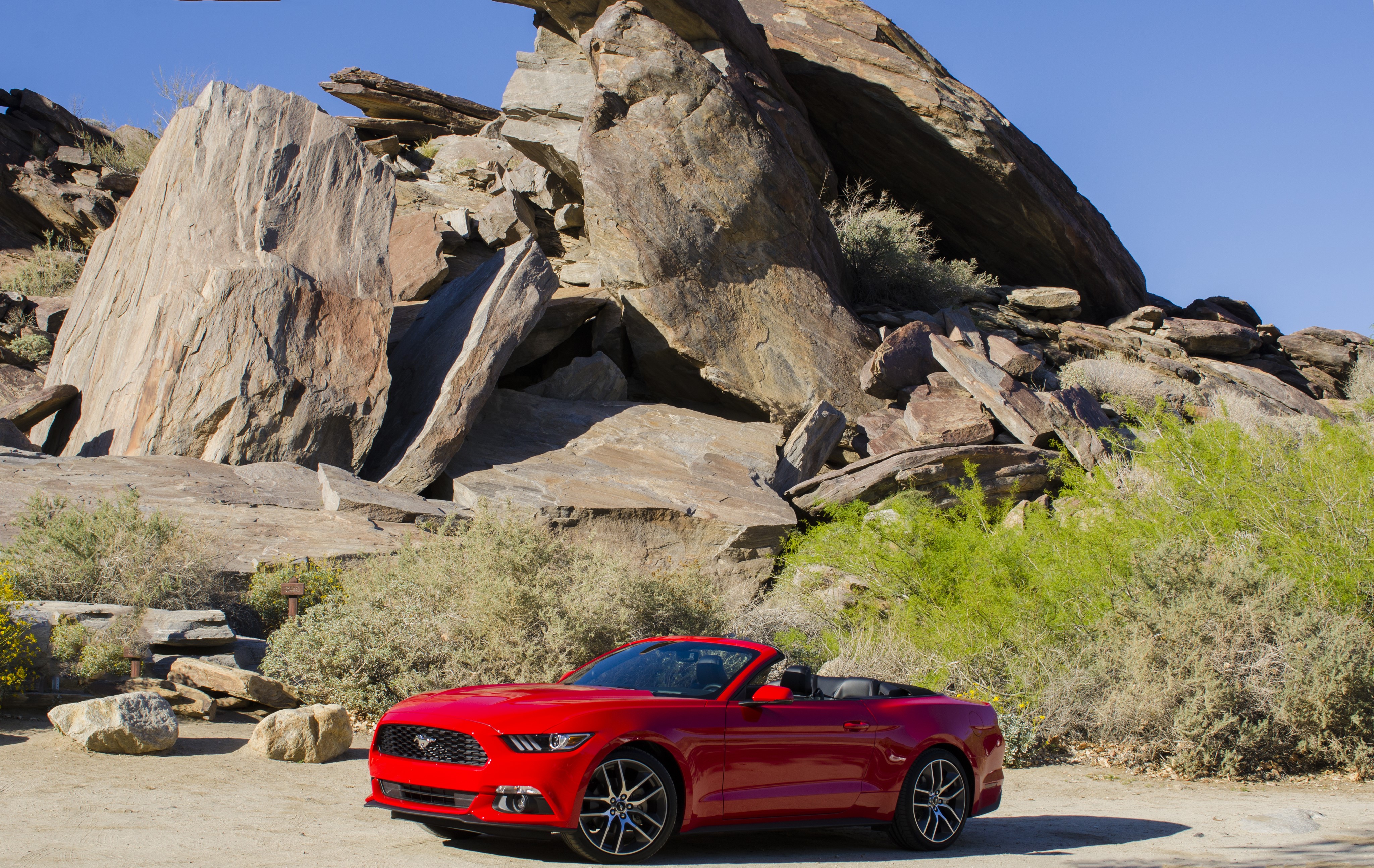 Red Ford Mustang Convertible in a Rocky Landscape HD Wallpaper