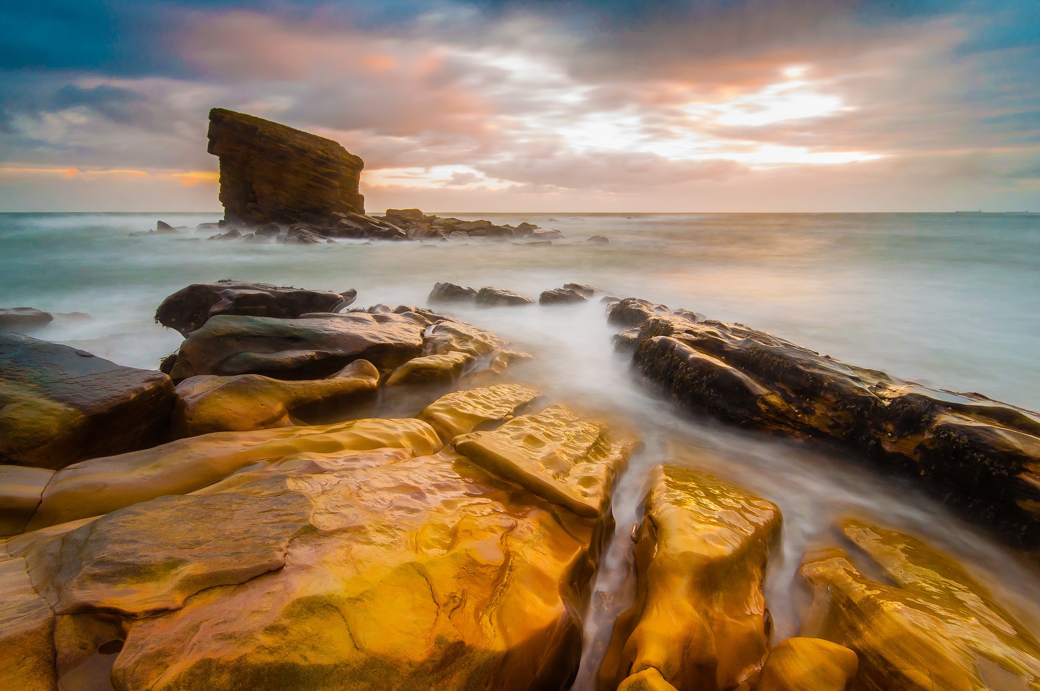 Rocky coastline with waves at sunset HD Wallpaper
