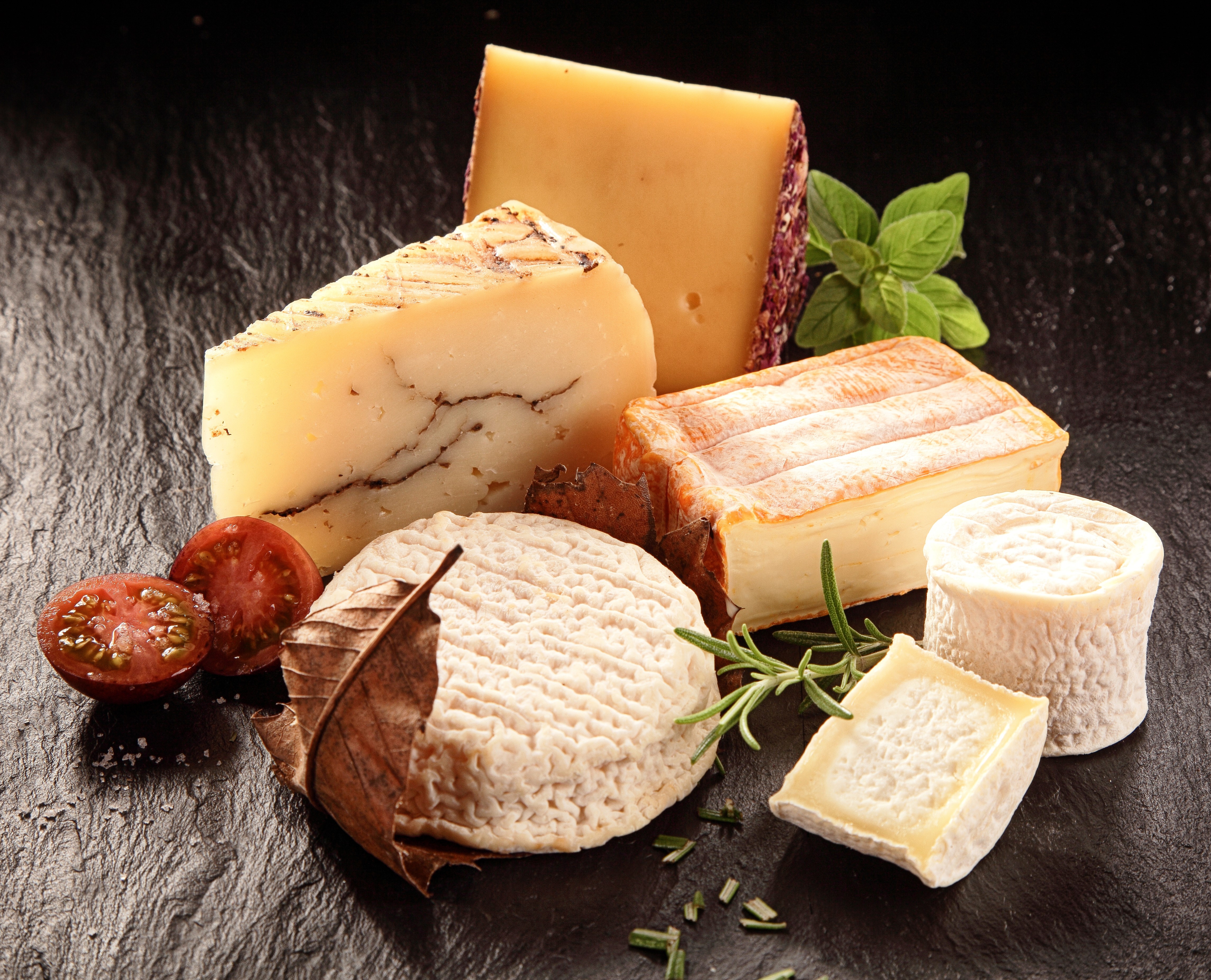 Assortment of Cheeses with Tomatoes and Herbs HD Wallpaper
