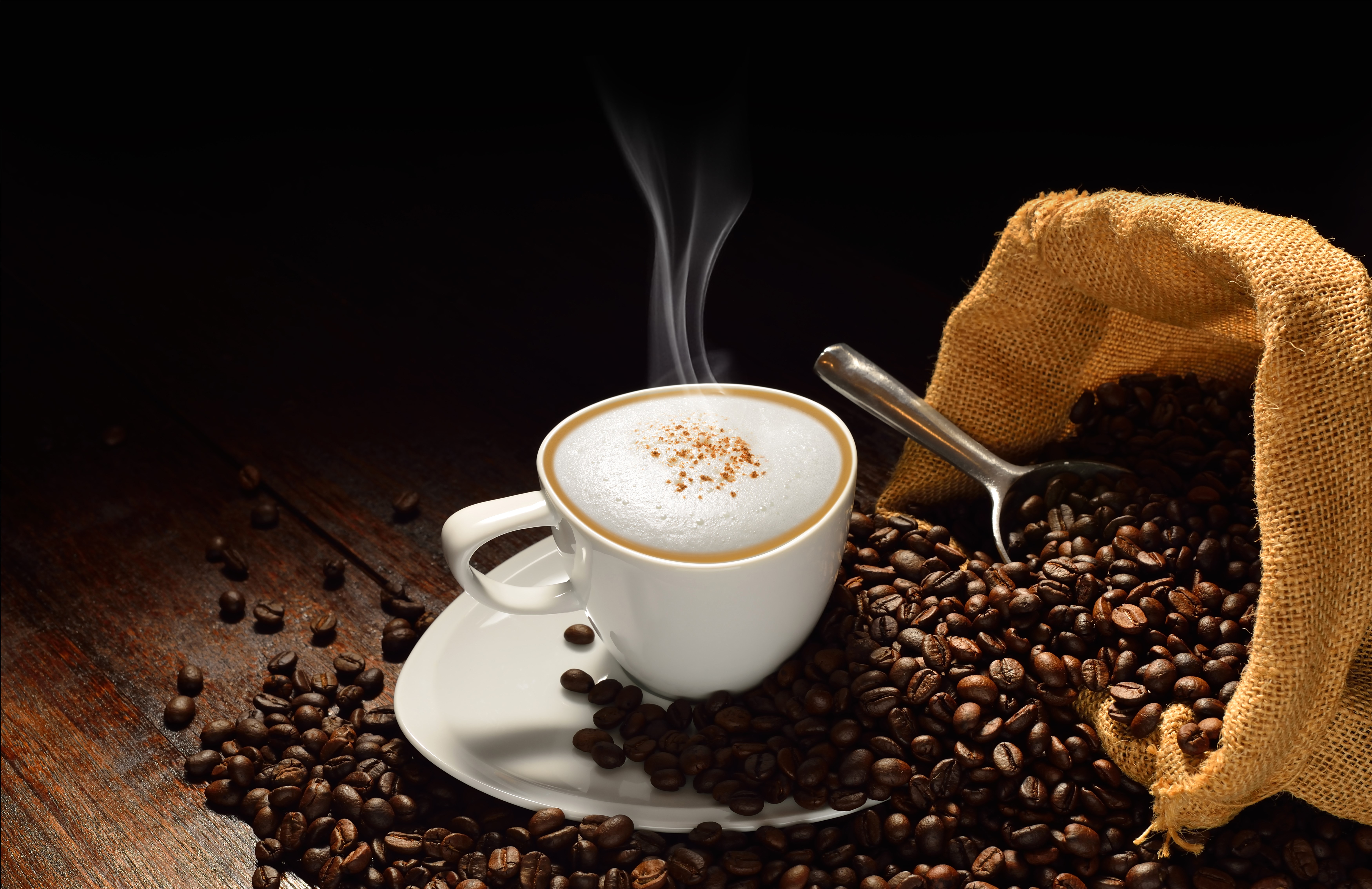 Cappuccino in a cup with coffee beans and burlap sack HD Wallpaper