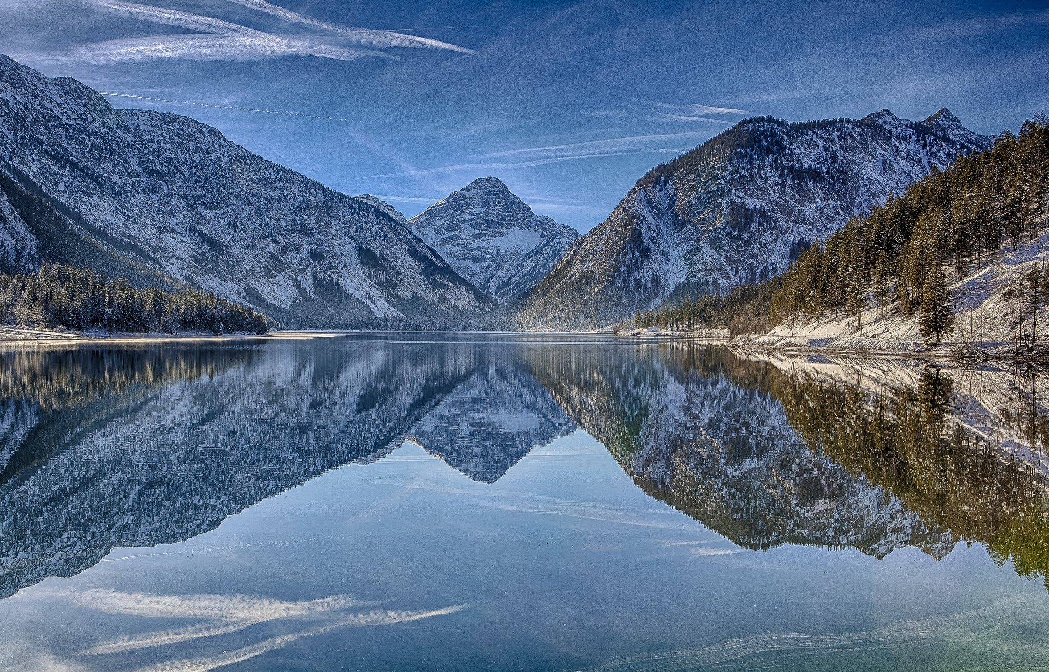 Snow-capped mountains reflected in a calm lake HD Wallpaper
