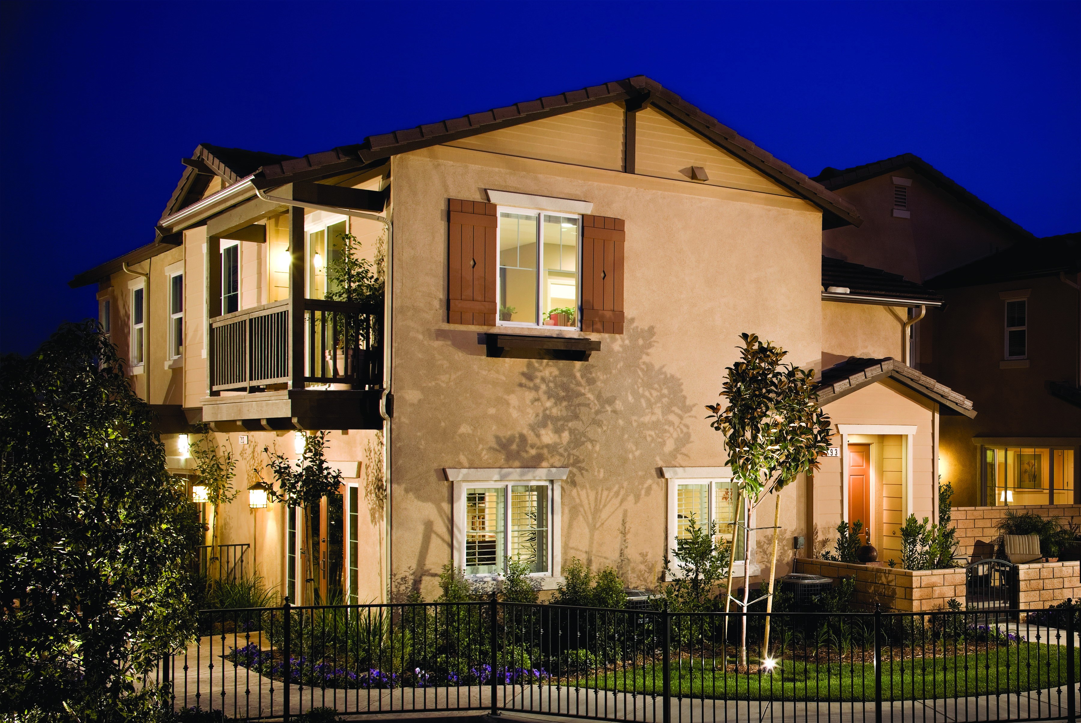 Two-story house at night with fence HD Wallpaper