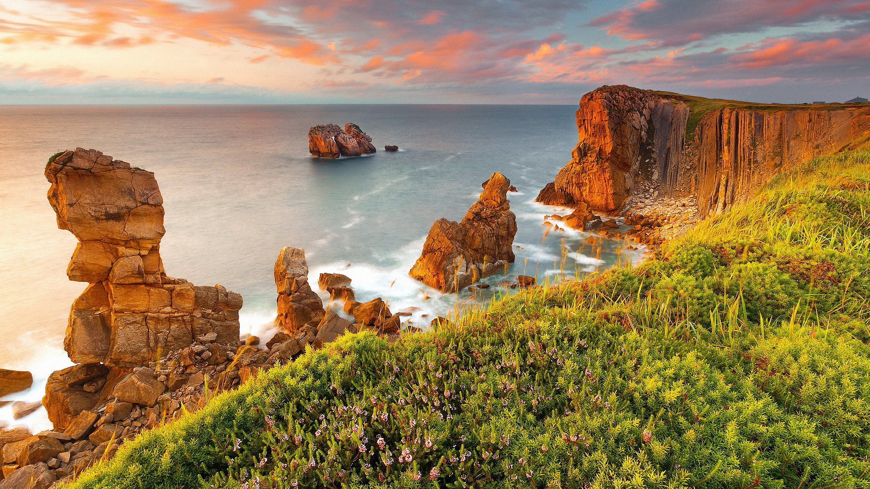 Coastal cliffs and rock formations at sunset HD Wallpaper