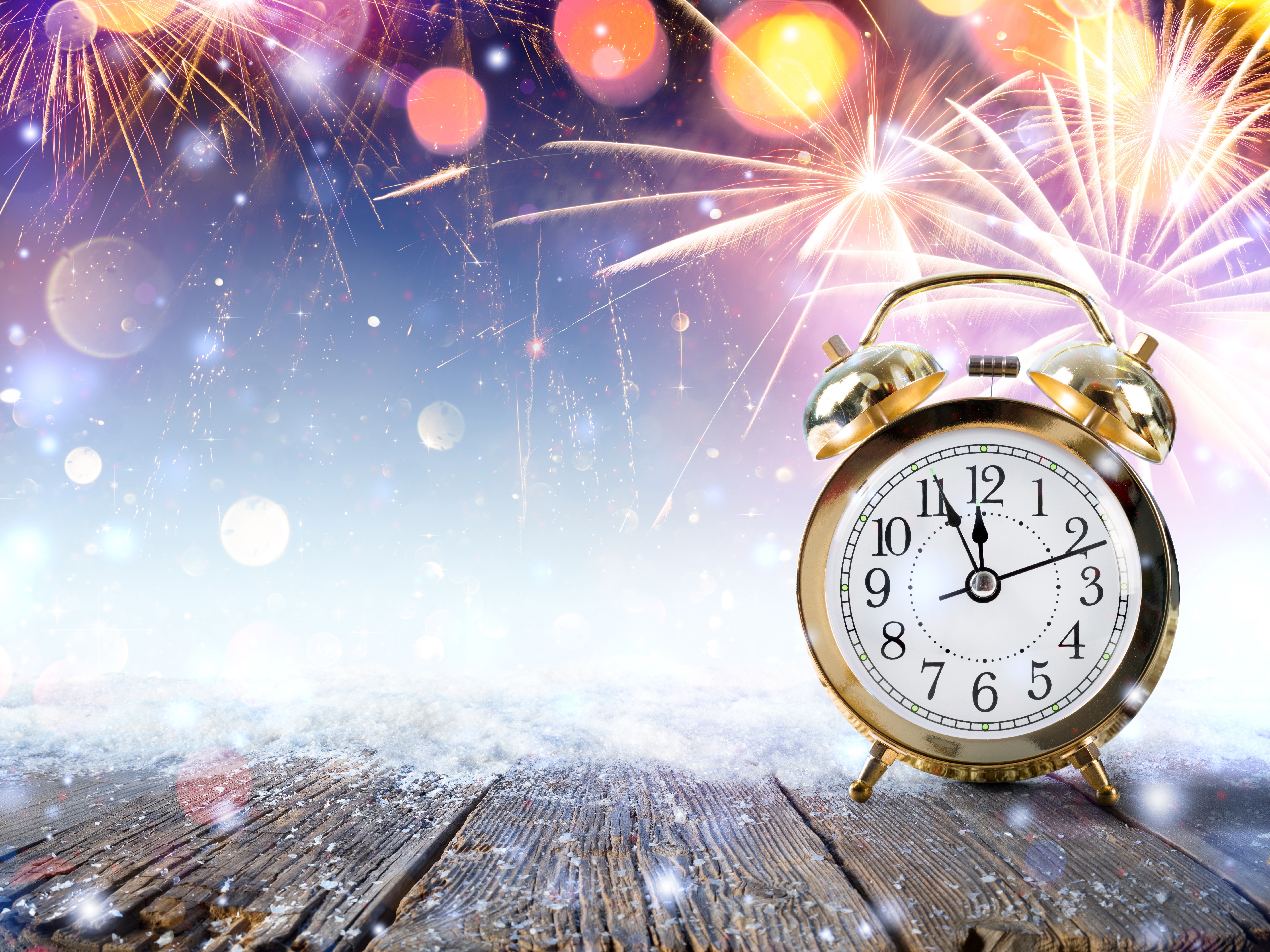 Alarm clock on wooden planks with fireworks HD Wallpaper