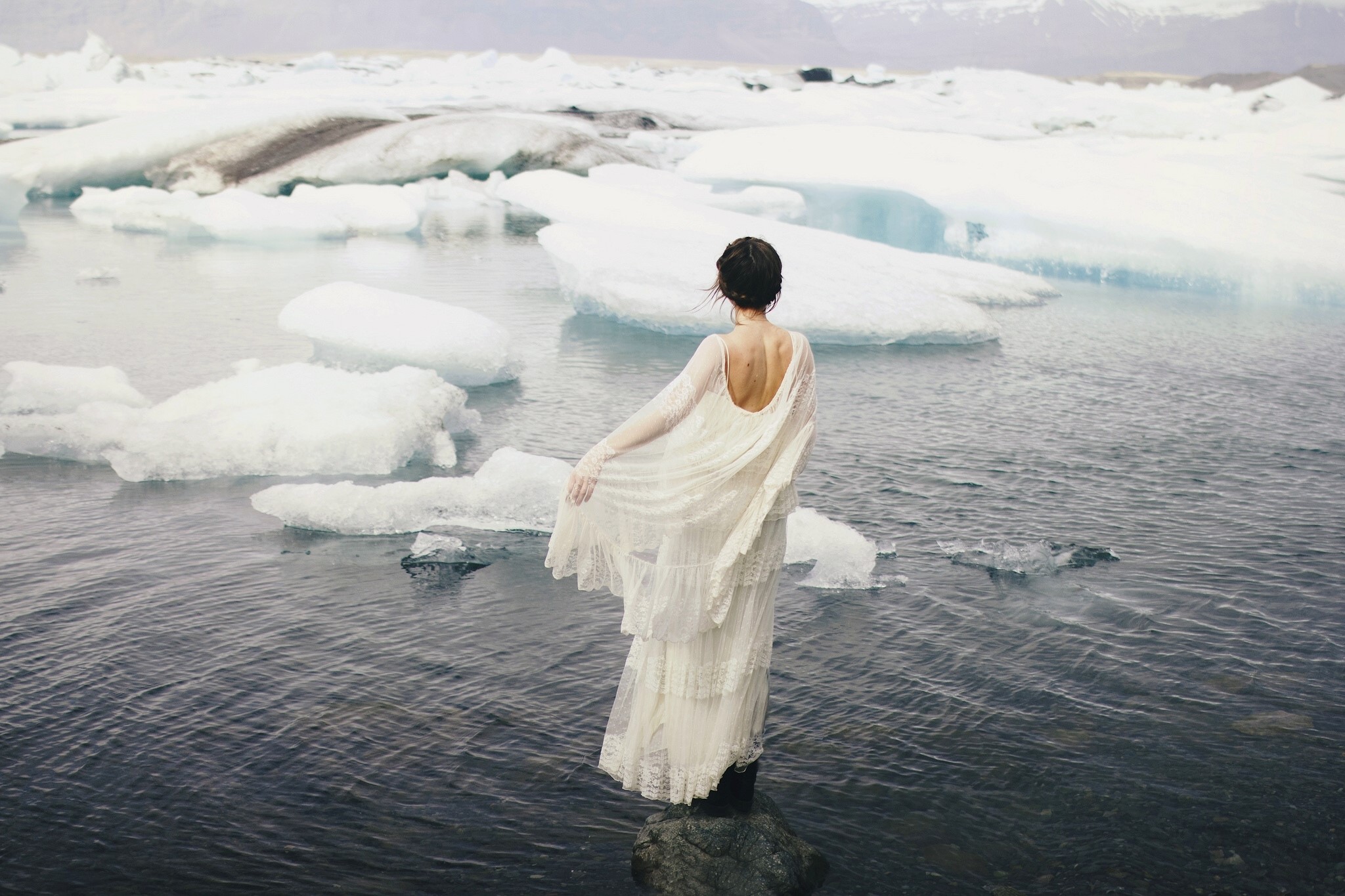 Woman in white dress standing in icy water HD Wallpaper