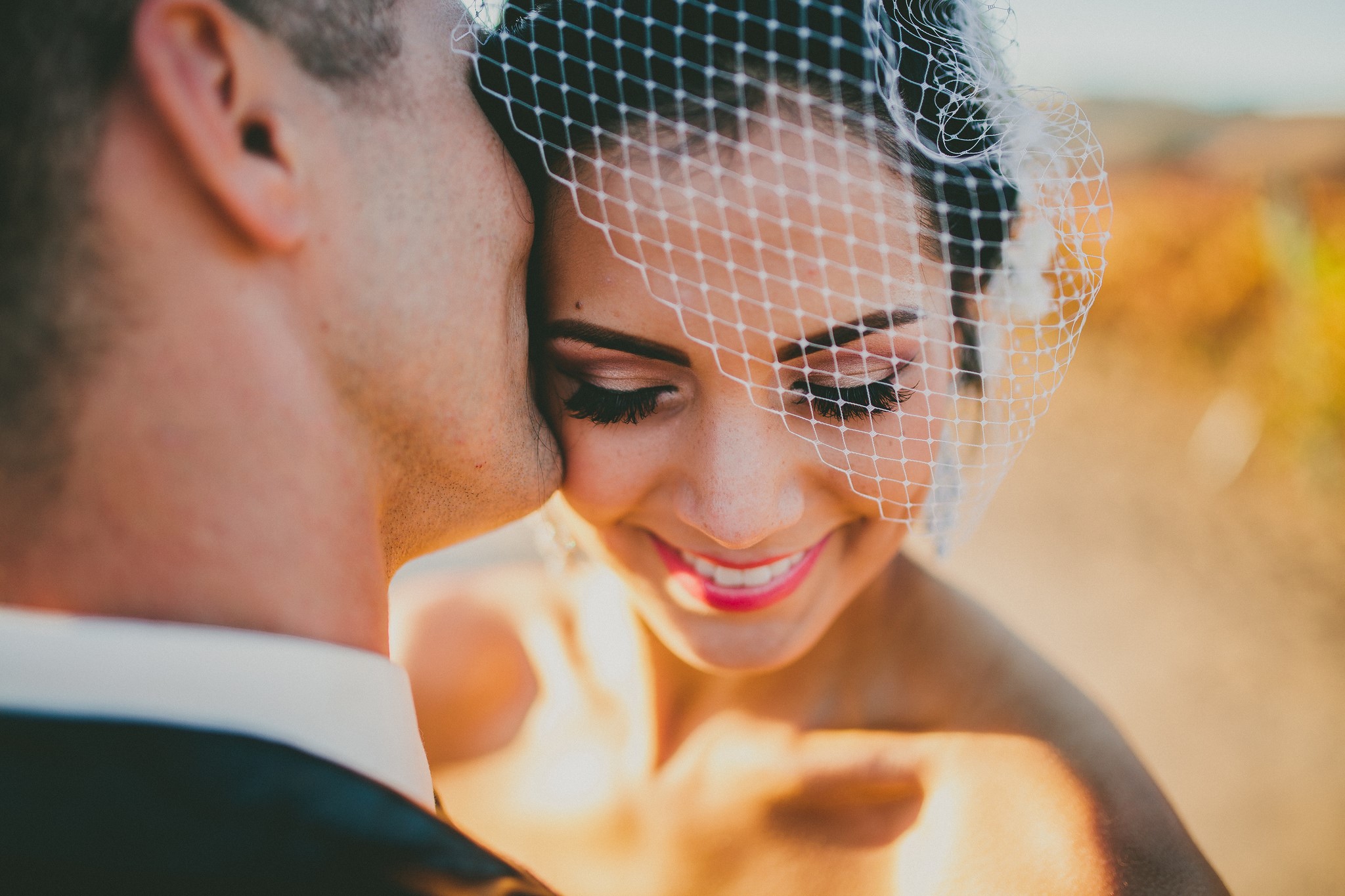 Bride wearing veil, groom kissing her cheek HD Wallpaper