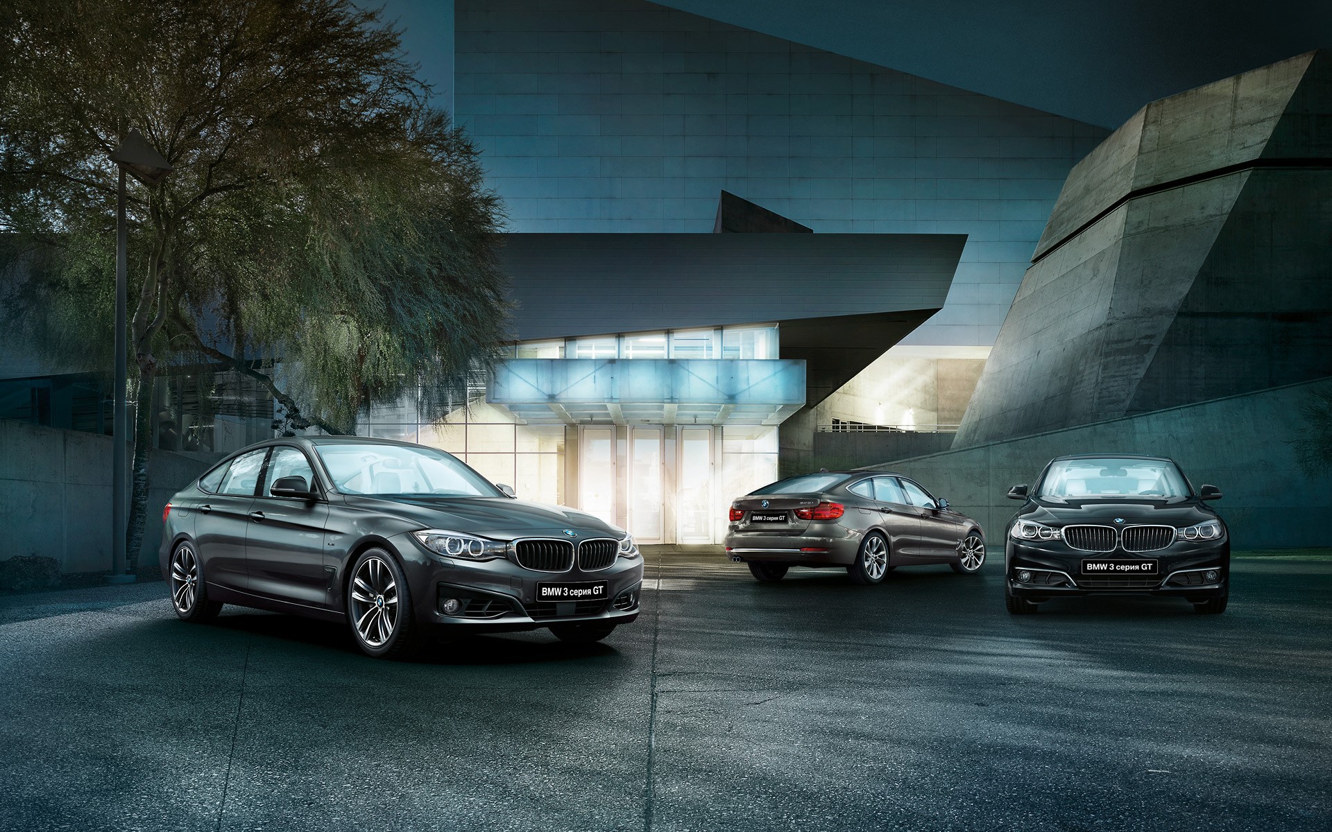 Three BMW 3 Series Gran Turismo cars parked outside a modern building HD Wallpaper