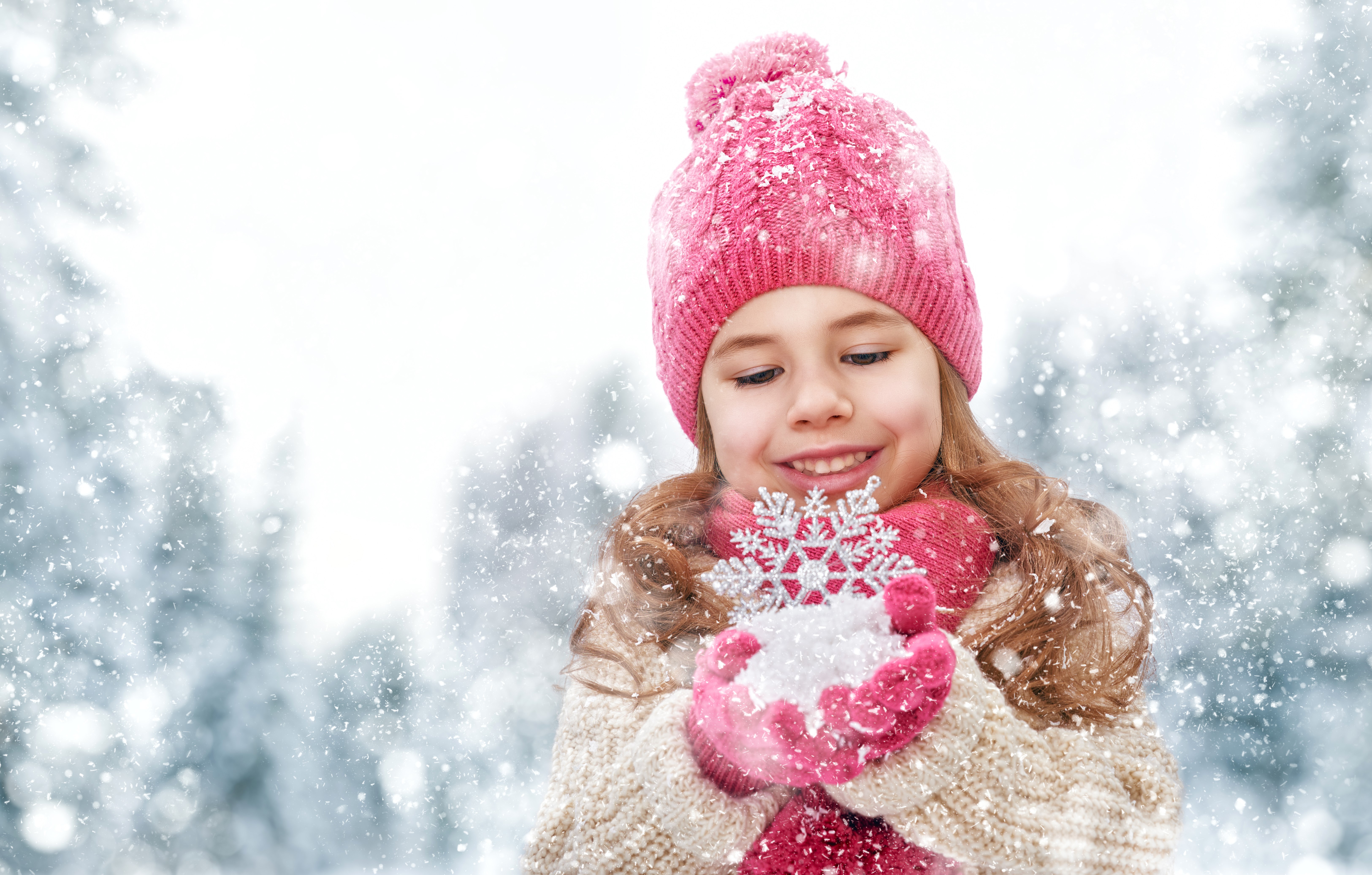 Little girl in winter hat holding snowflake HD Wallpaper