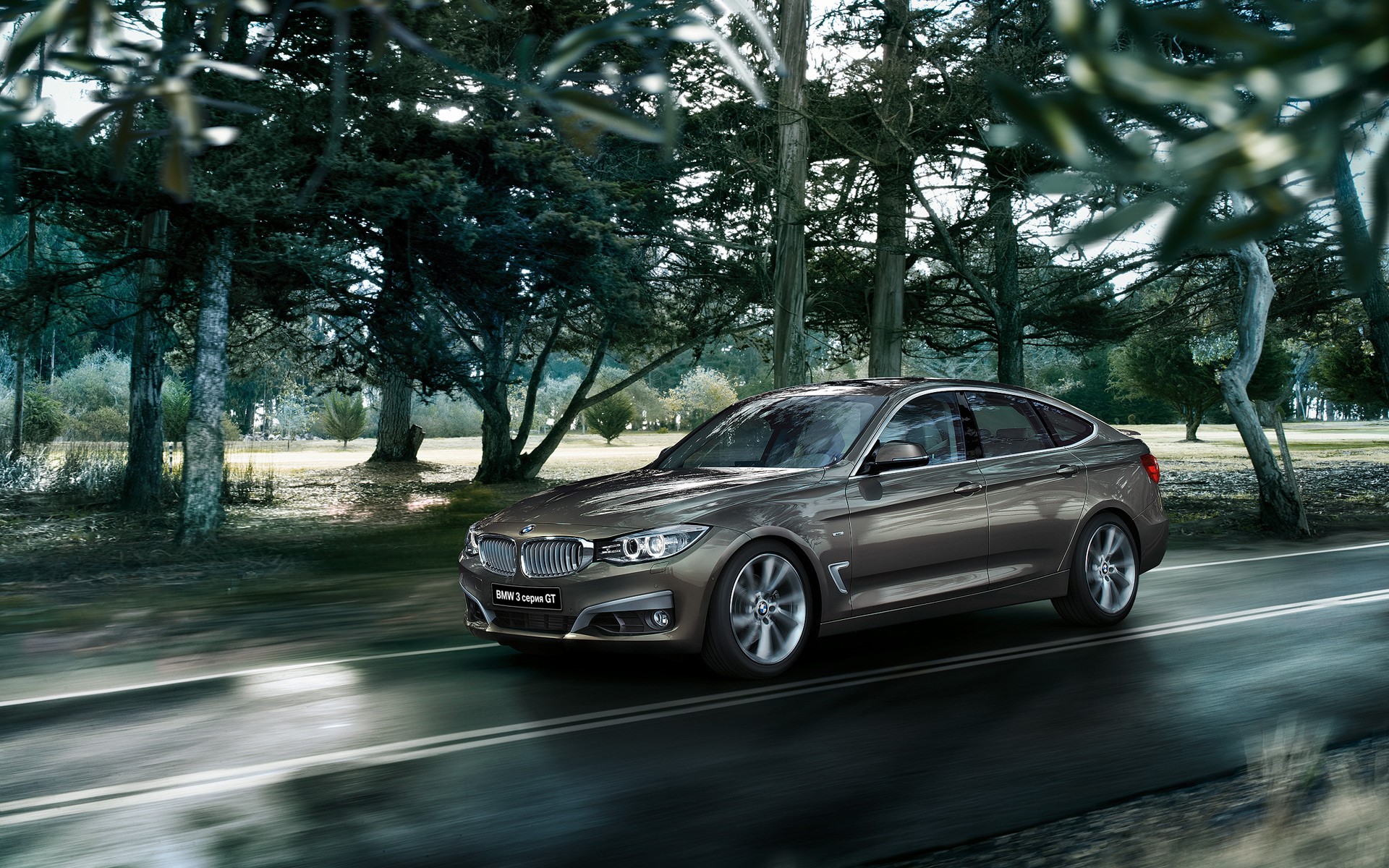 BMW 3 Series Gran Turismo driving on a road HD Wallpaper