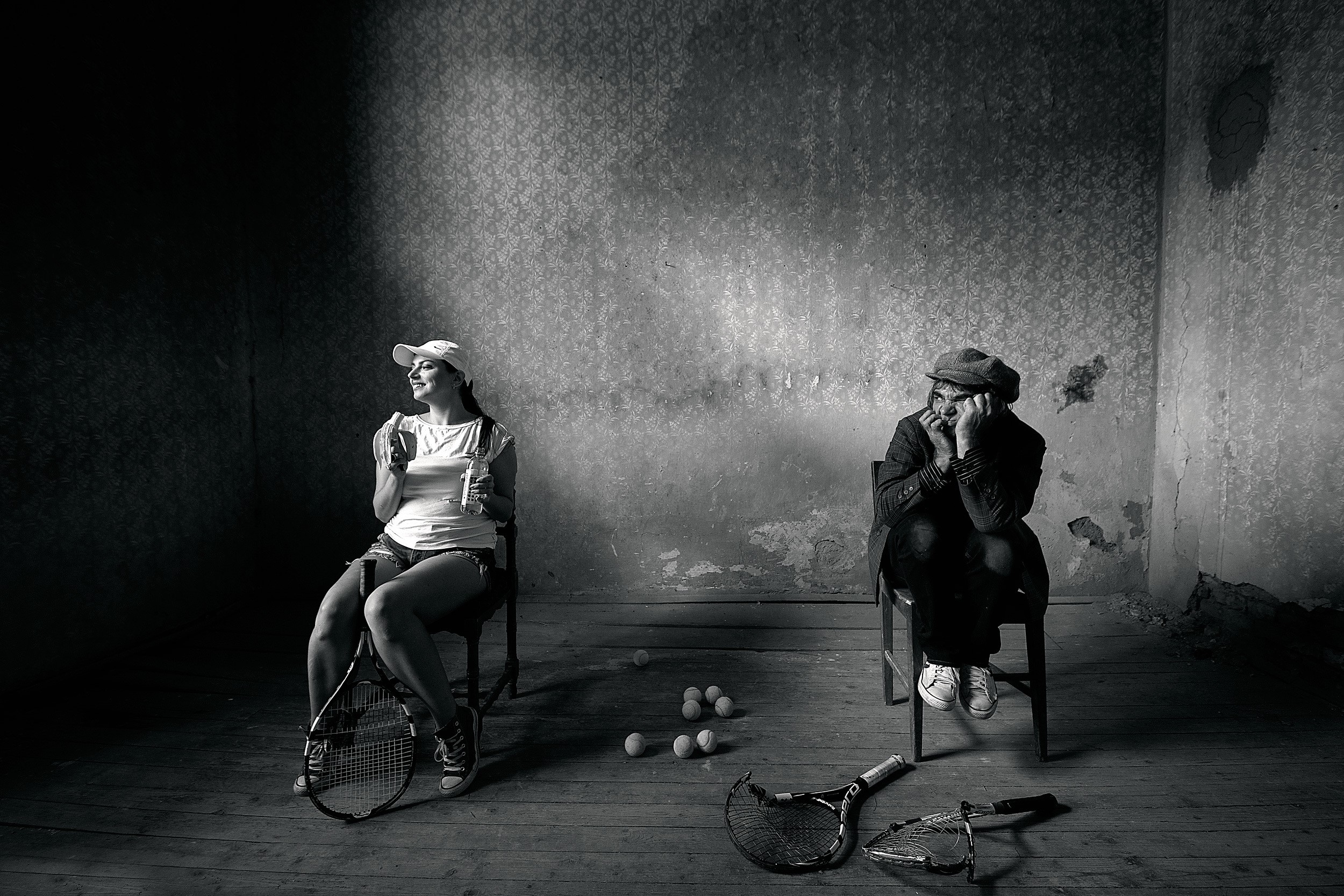 Man and woman with tennis rackets in a room HD Wallpaper
