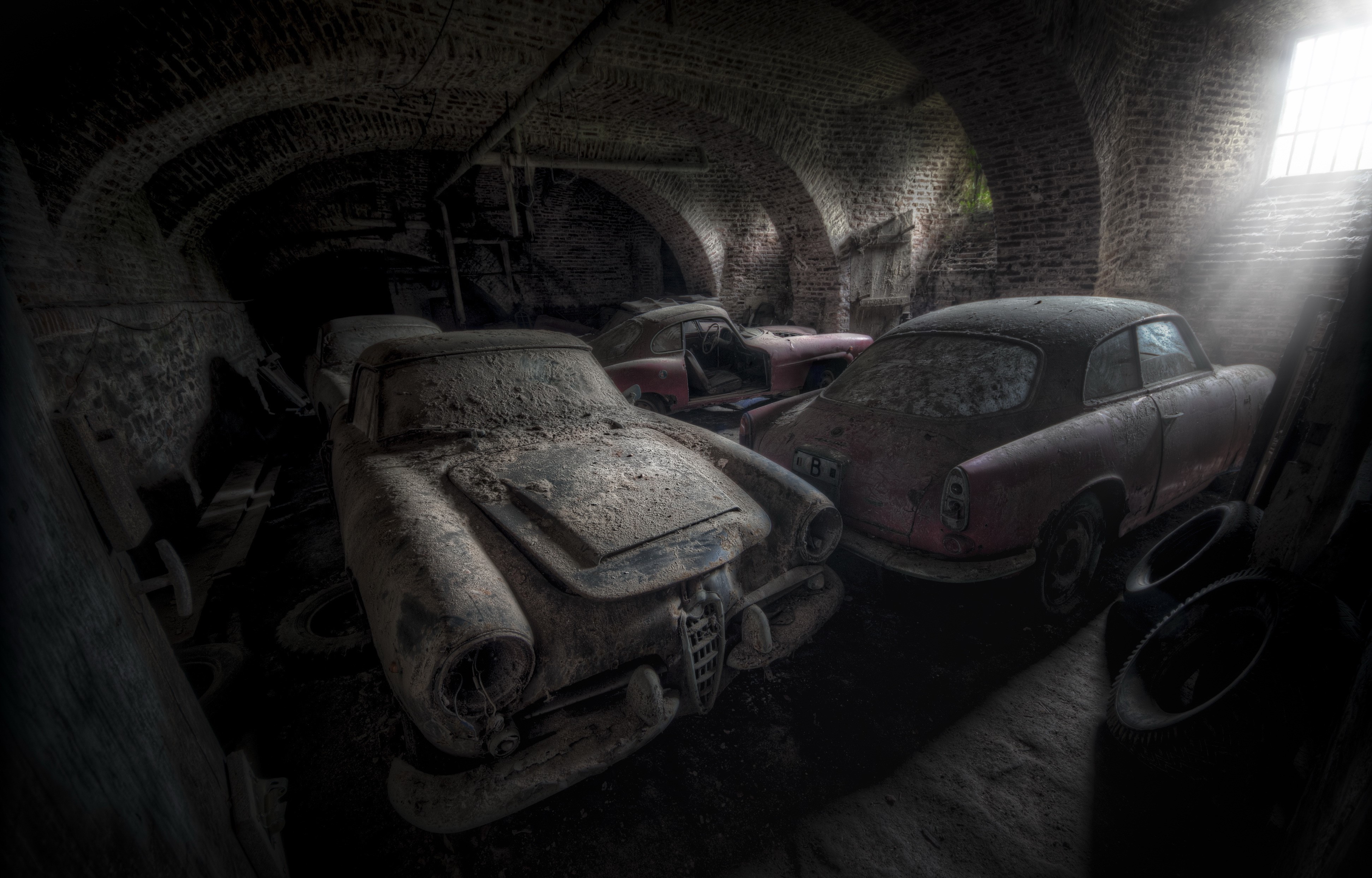 Abandoned vintage cars in a brick garage HD Wallpaper
