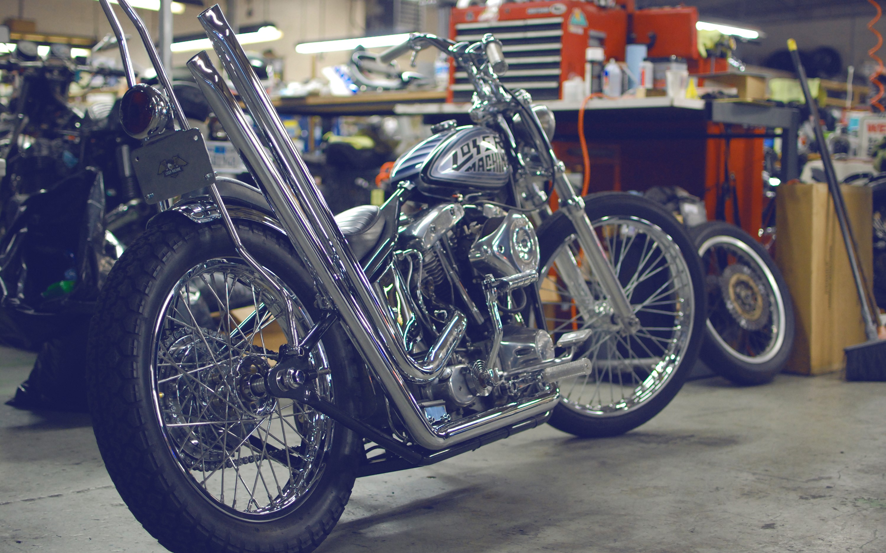 Custom Chopper Motorcycle in a Garage HD Wallpaper