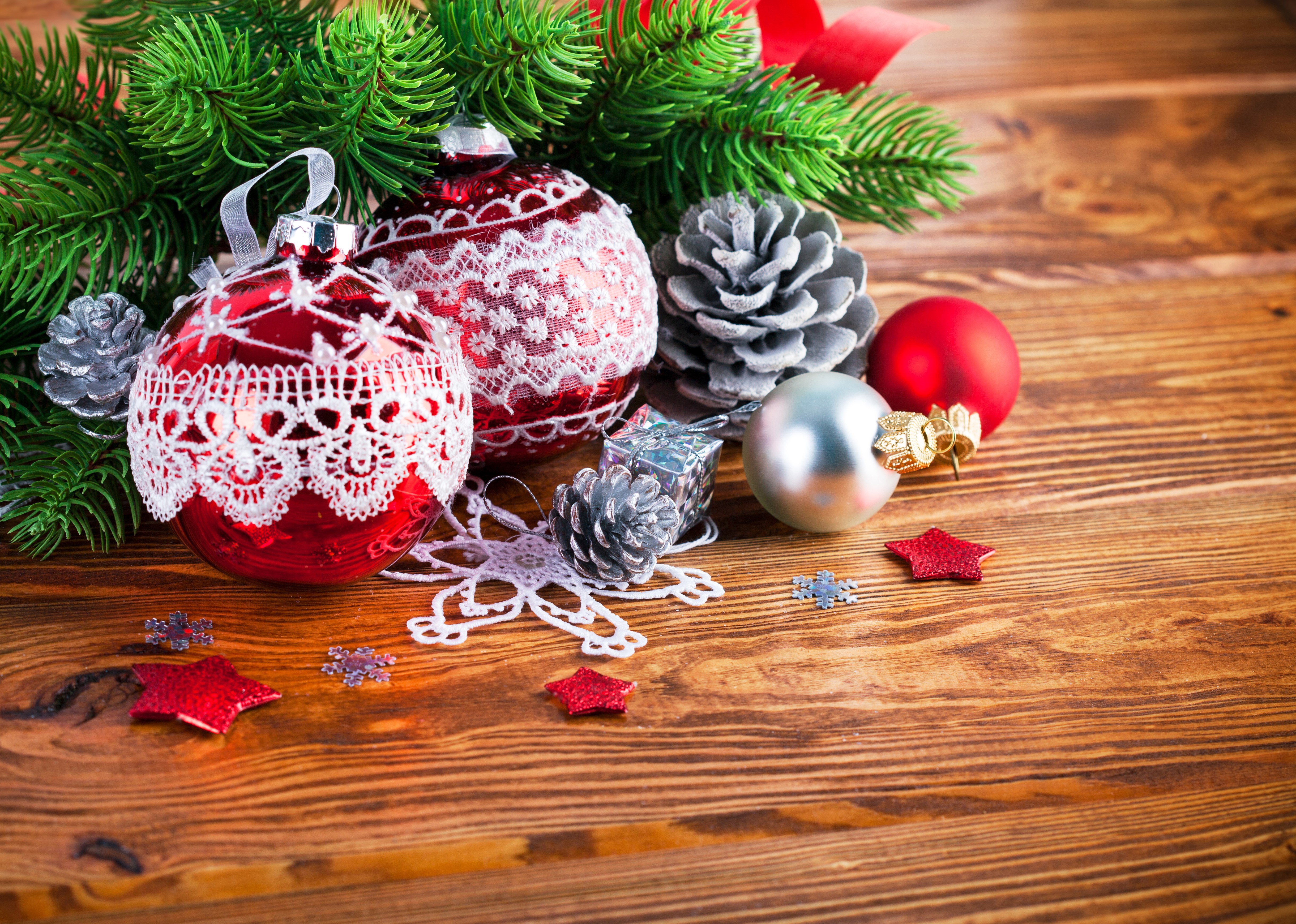 Christmas ornaments and pine cones on wooden background HD Wallpaper