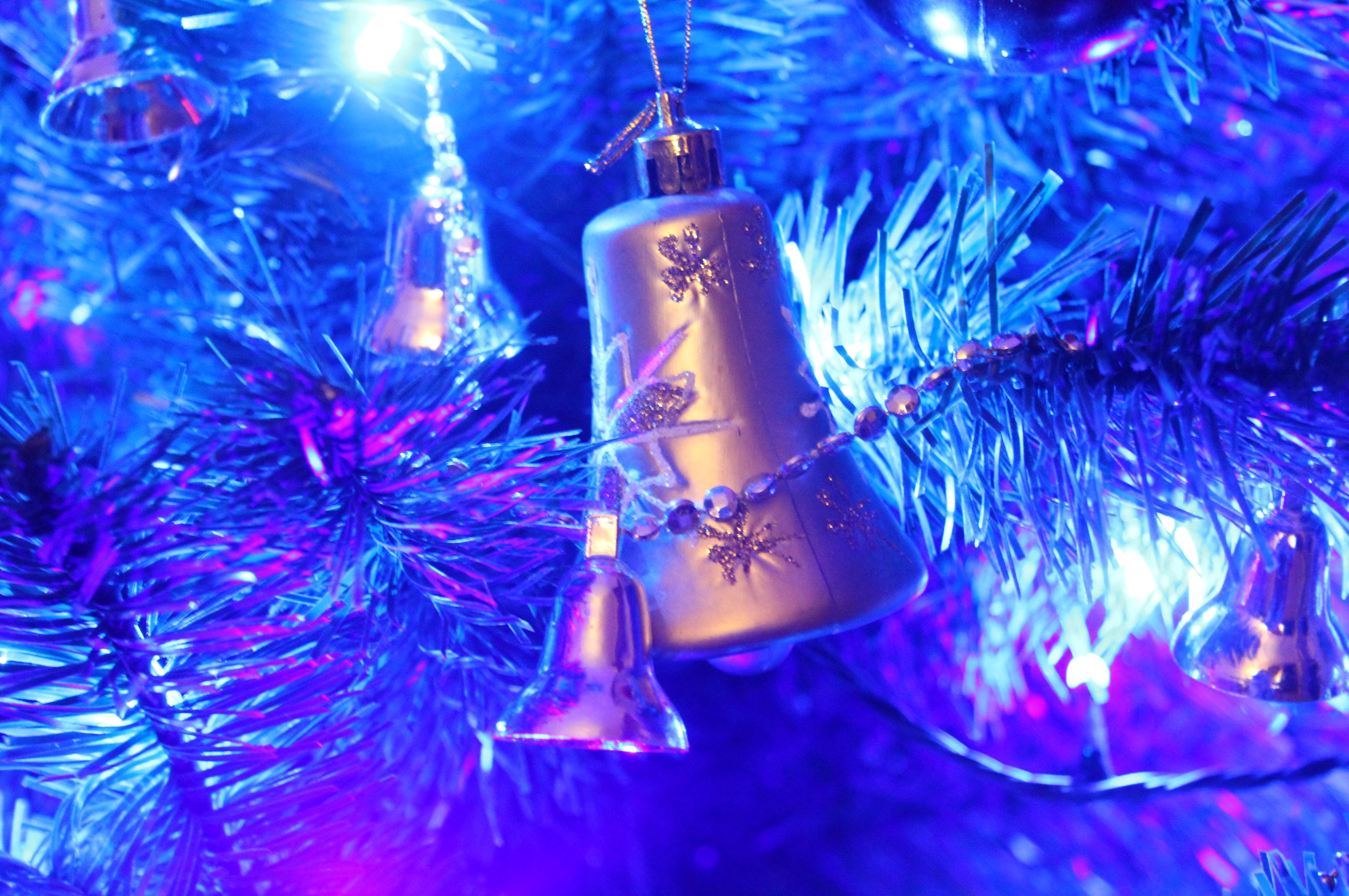 Christmas tree with blue lights and bell ornaments HD Wallpaper