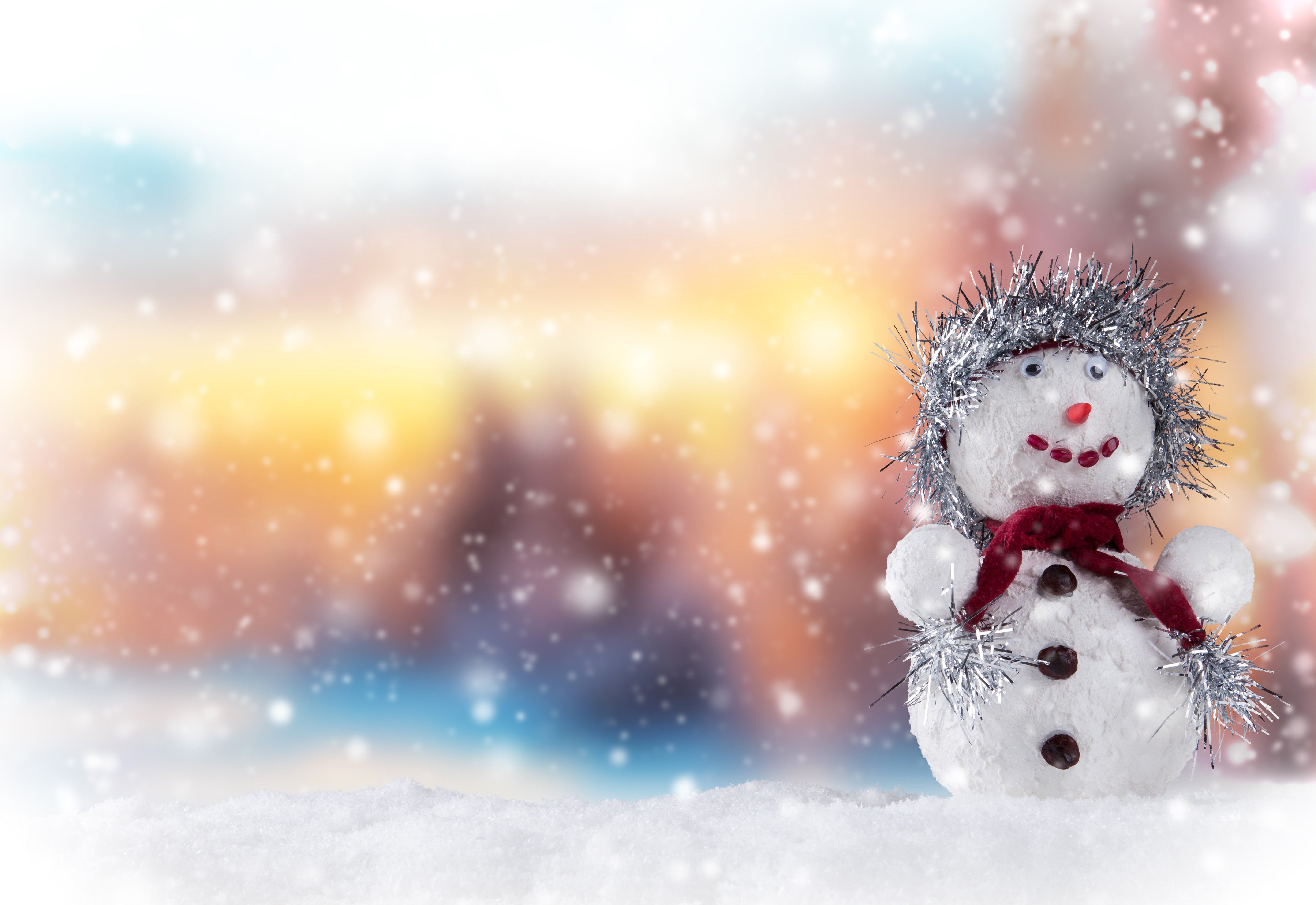 Snowman with tinsel hat and scarf in snow HD Wallpaper