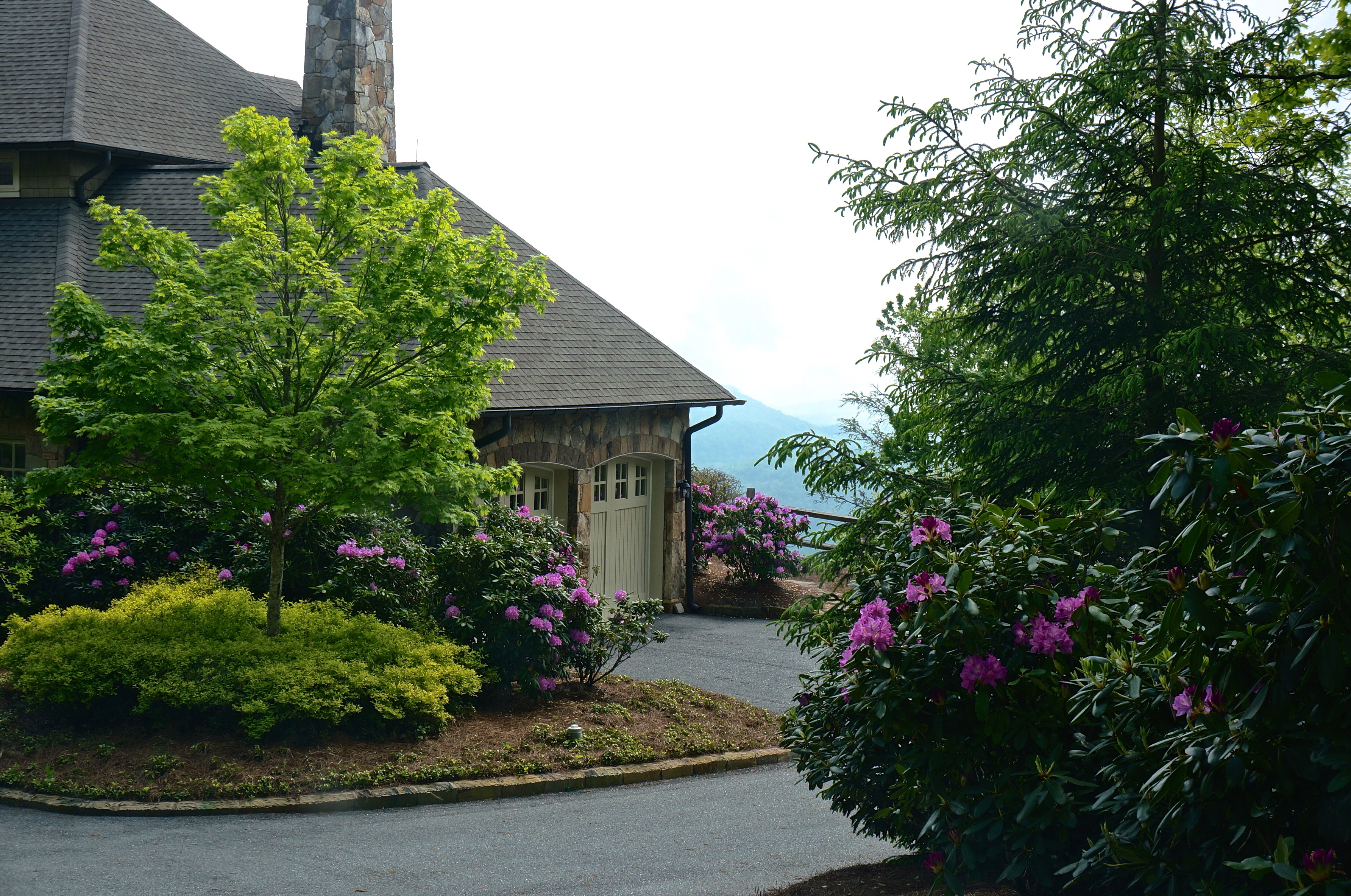 House with garage and flowering shrubs in mountains HD Wallpaper