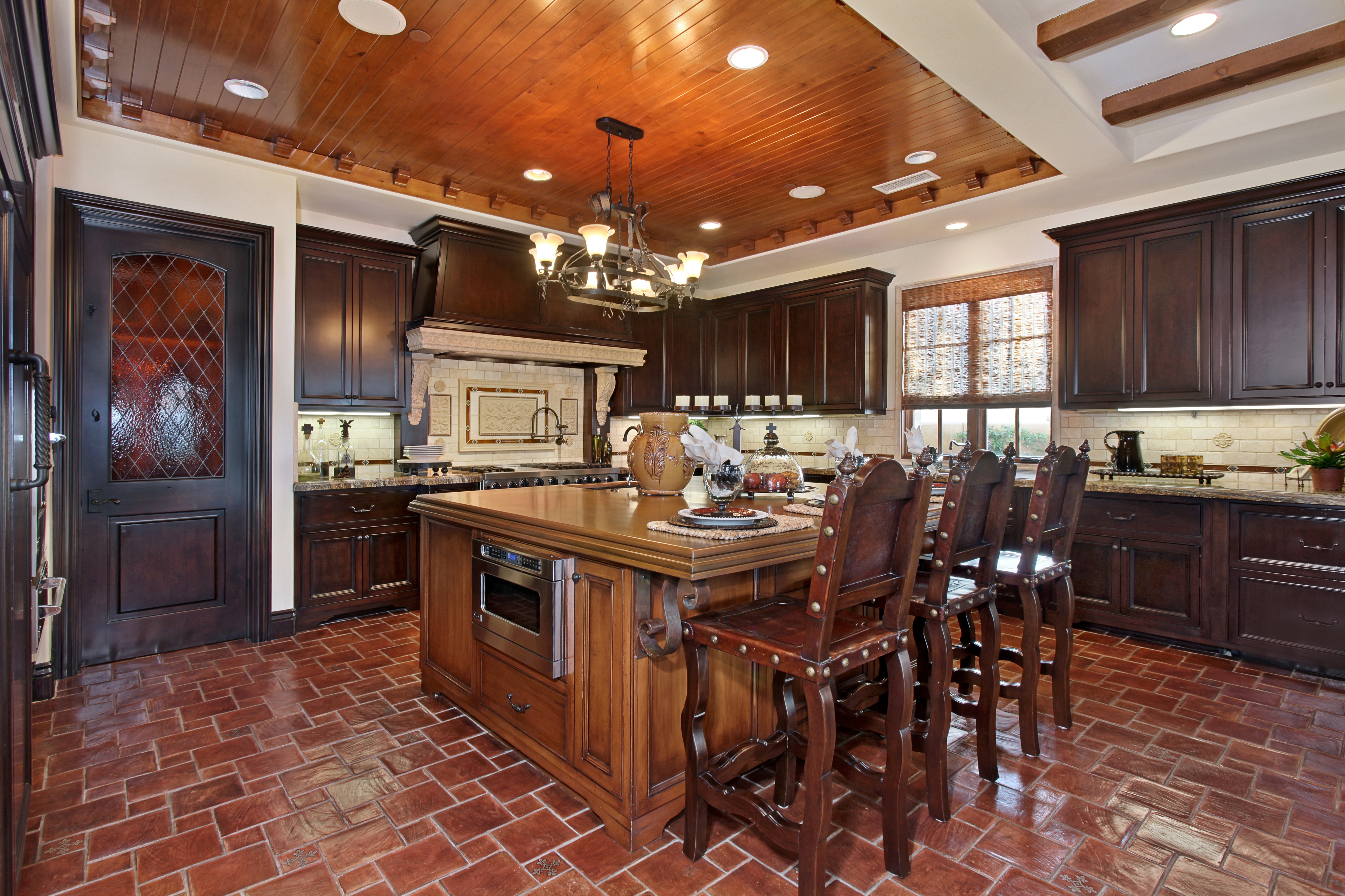 Kitchen with wooden ceiling, island, and chairs HD Wallpaper