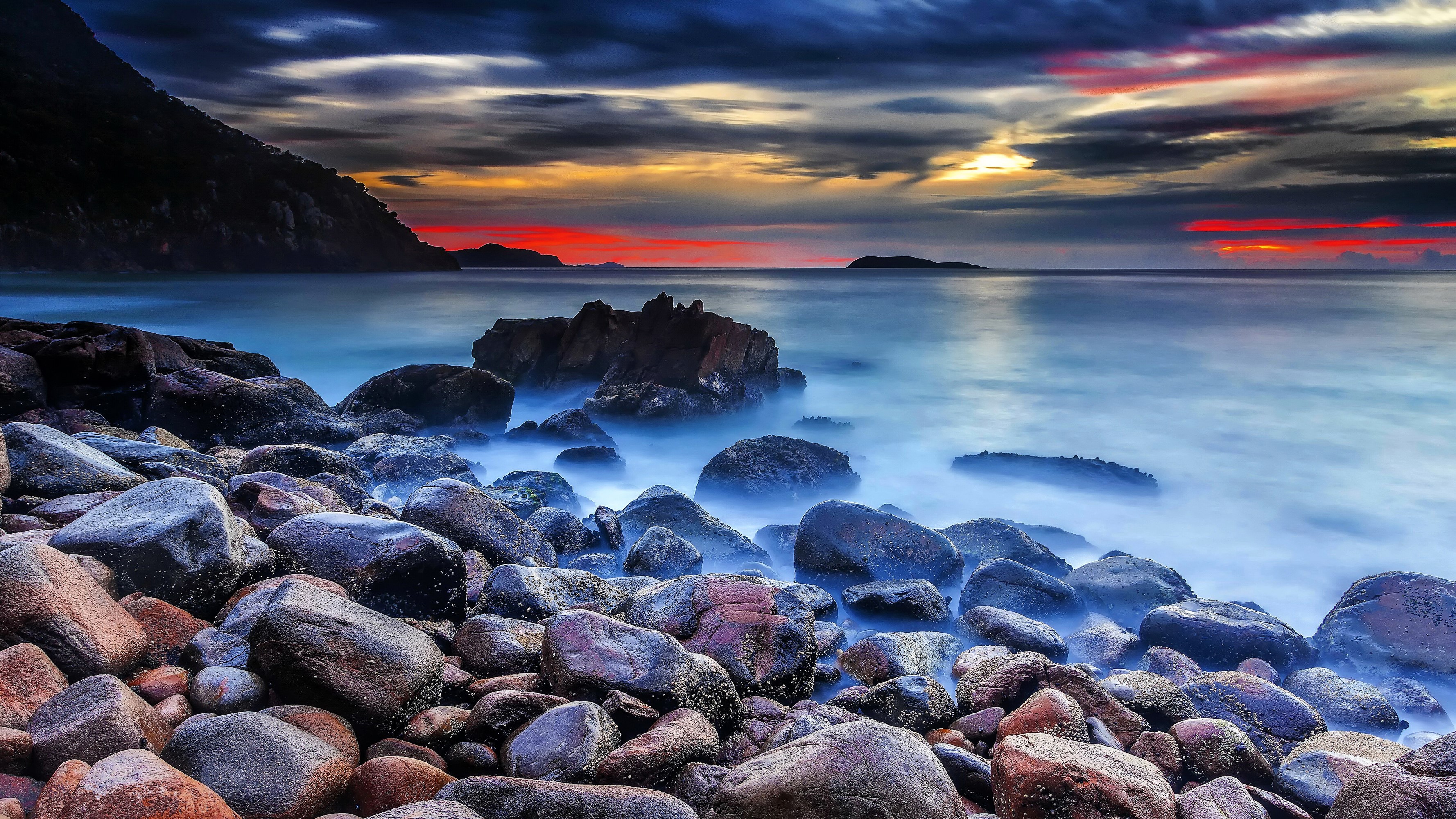 Rocky Coastline at Sunset with Dramatic Clouds HD Wallpaper