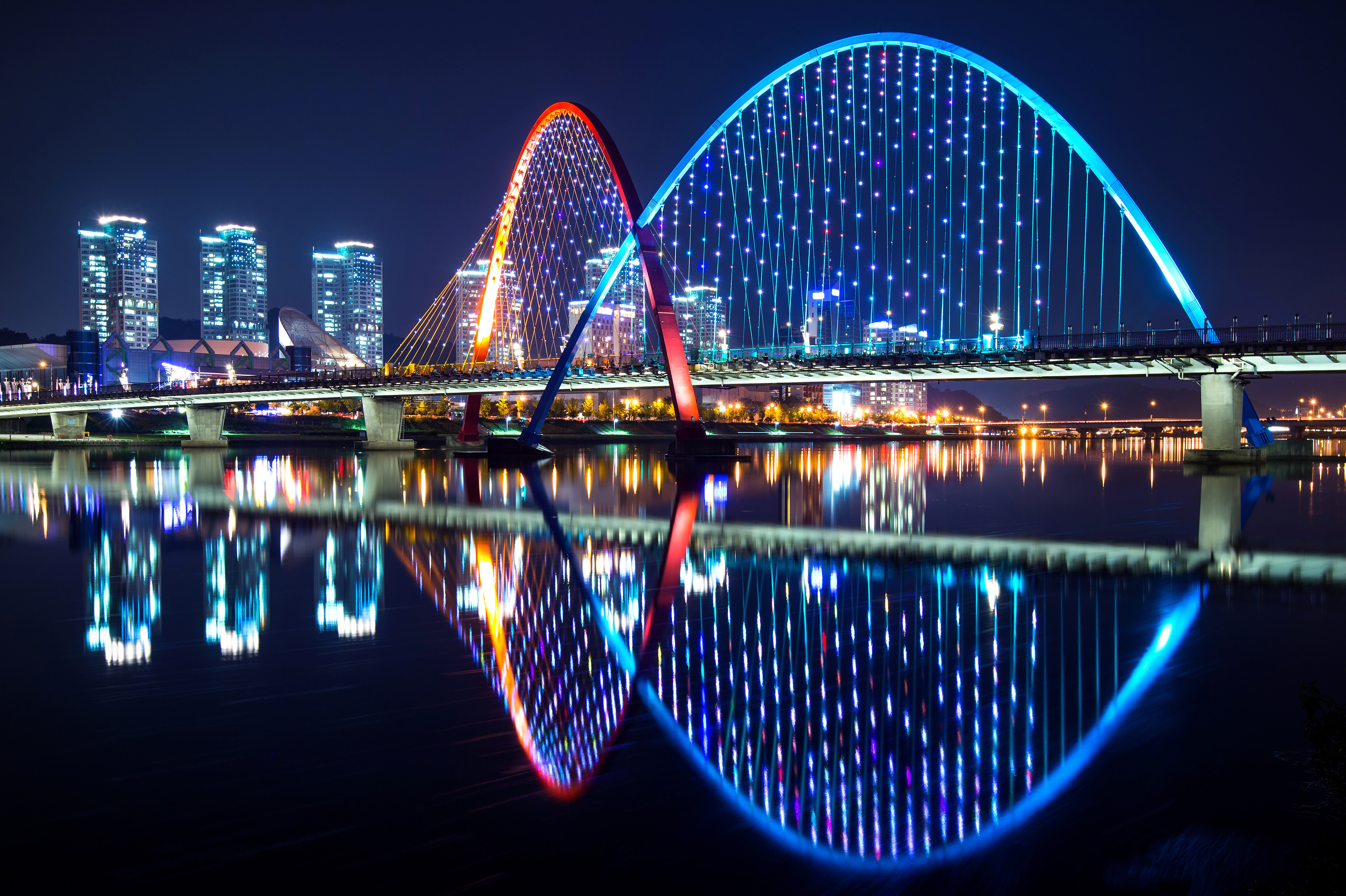 Illuminated Arched Bridges Over River at Night in Daejeon, South Korea HD Wallpaper