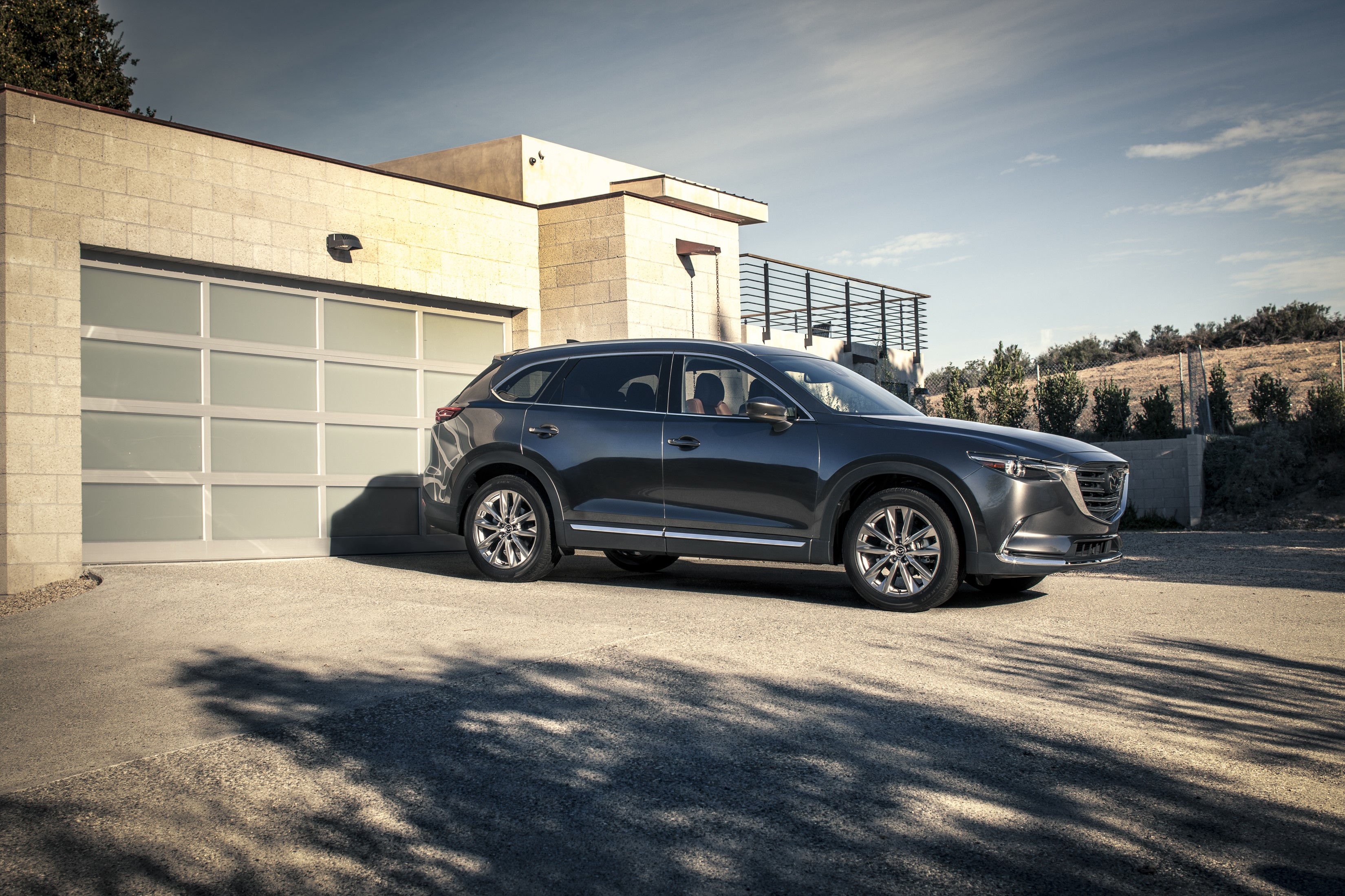 Mazda CX-9 parked in front of a modern garage HD Wallpaper