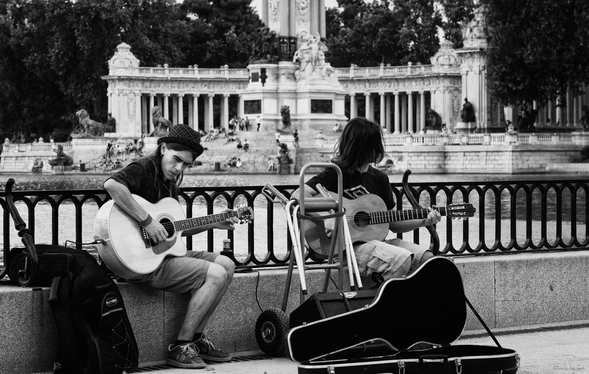 Two men playing guitars in front of a monument HD Wallpaper