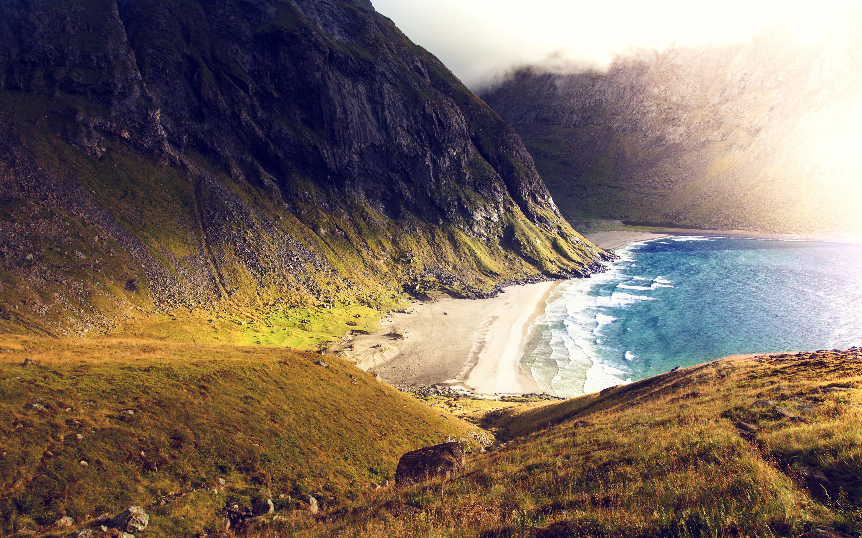 Mountains overlooking a beach and the sea HD Wallpaper