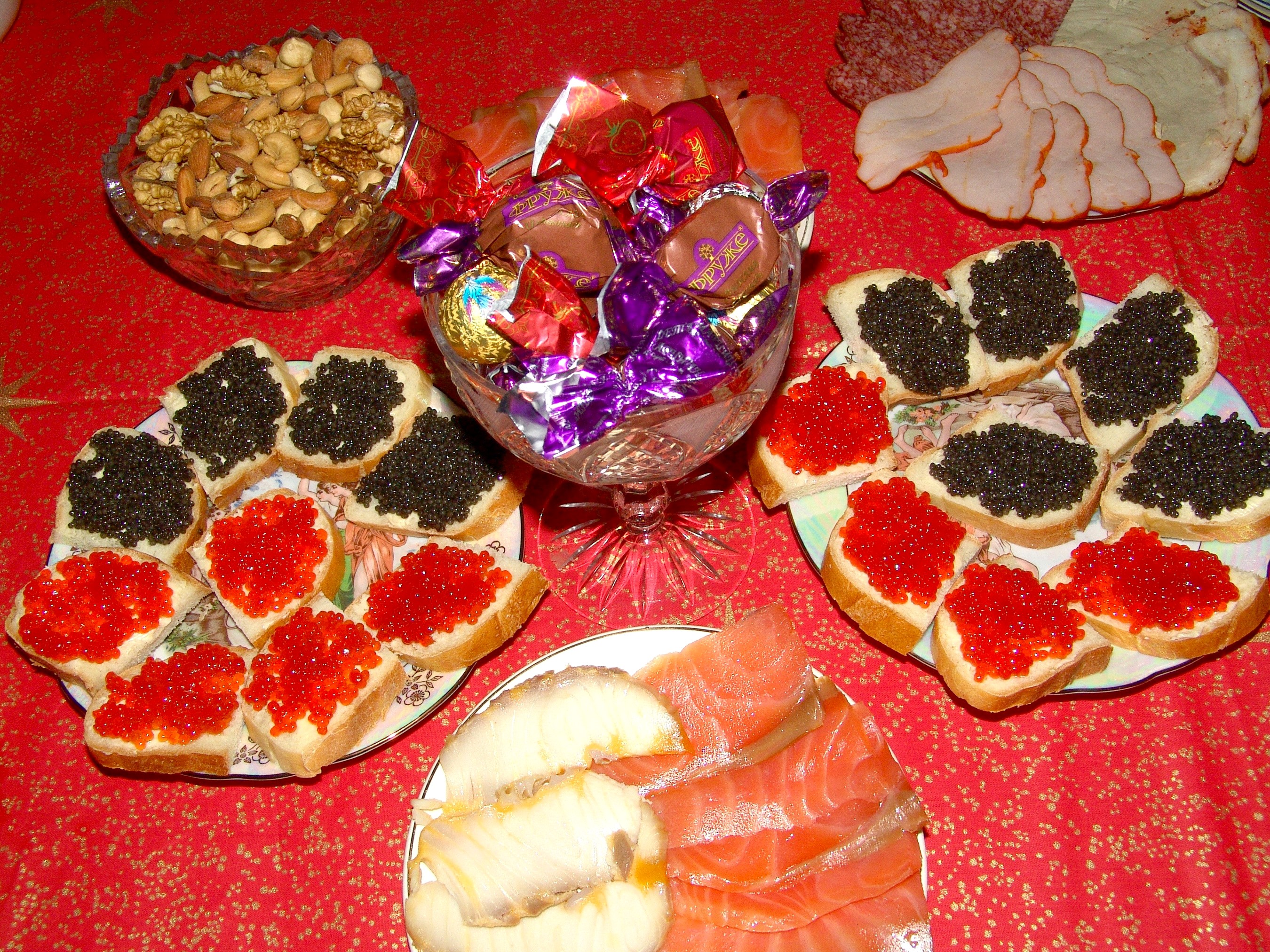Assortment of caviar sandwiches, nuts, candies, and sliced meats HD Wallpaper