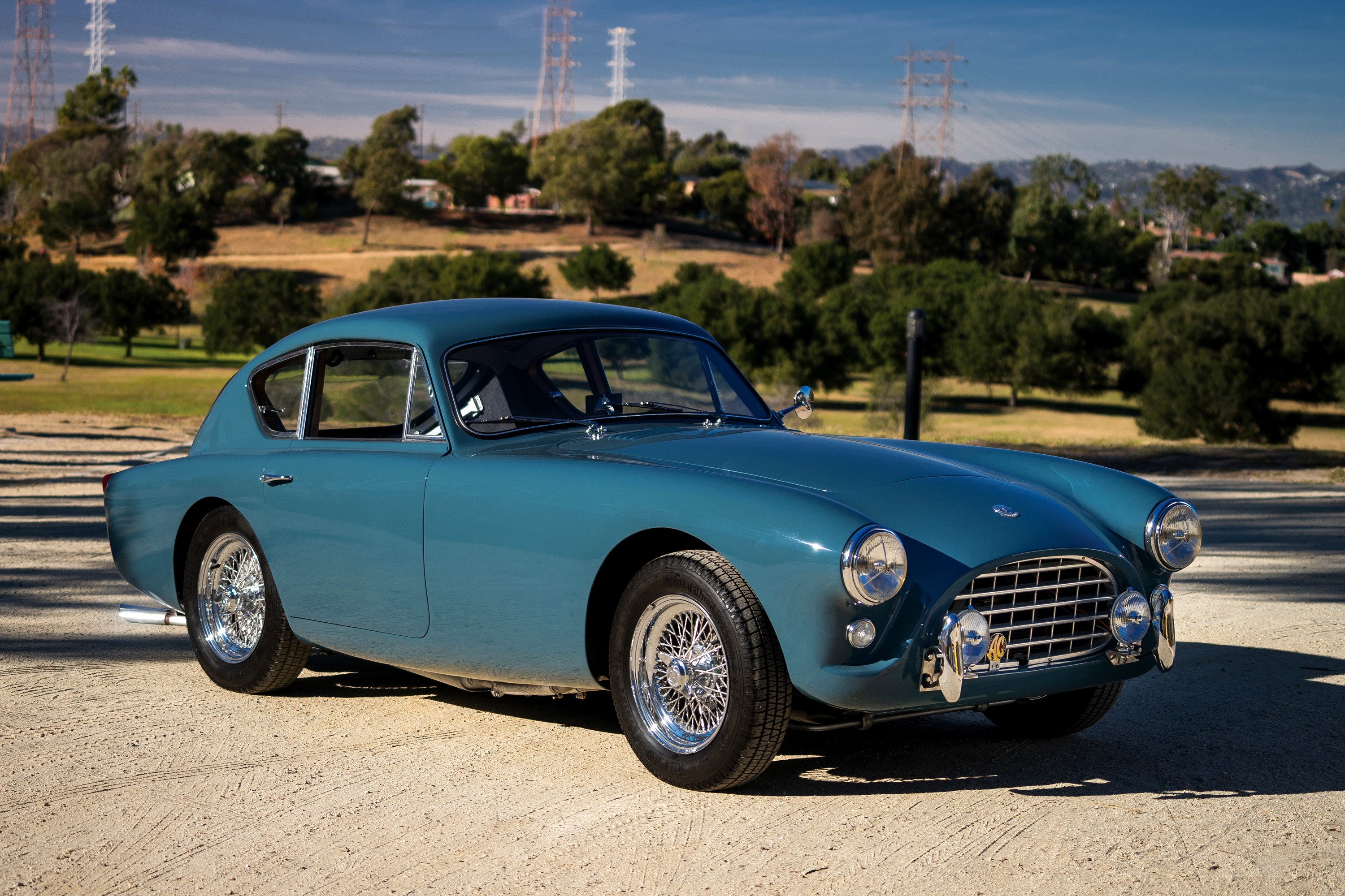 Blue AC Cobra coupe parked on a dirt road HD Wallpaper