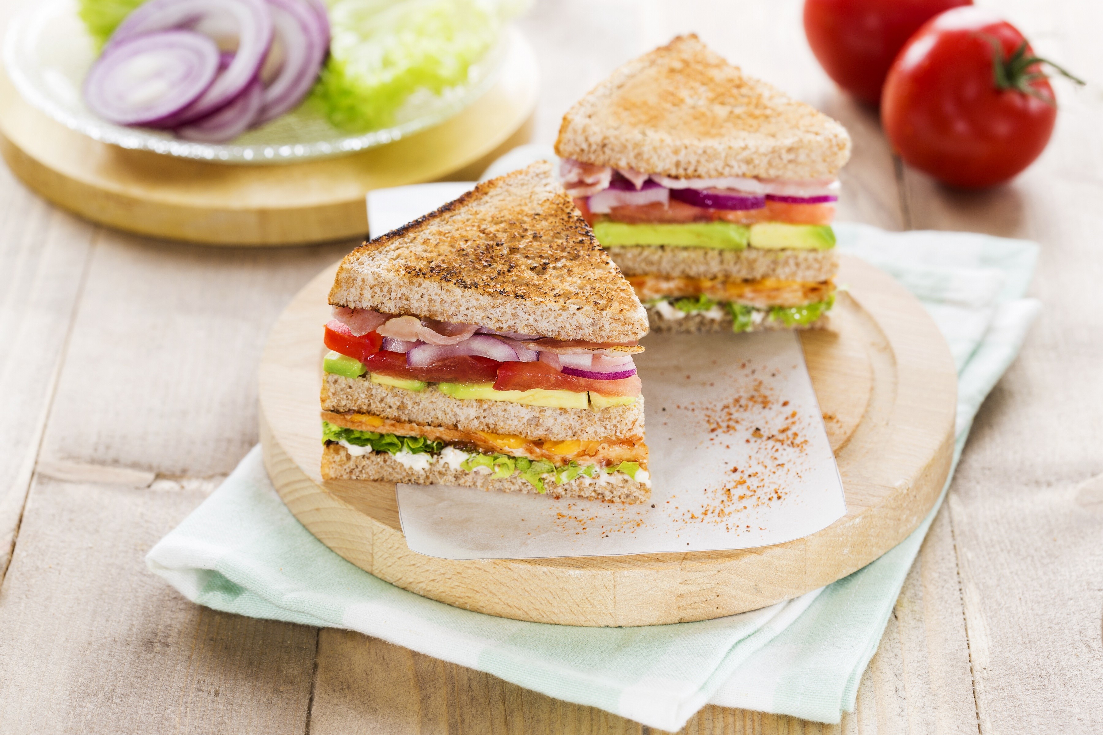 Two club sandwiches with avocado, tomato, and ham HD Wallpaper