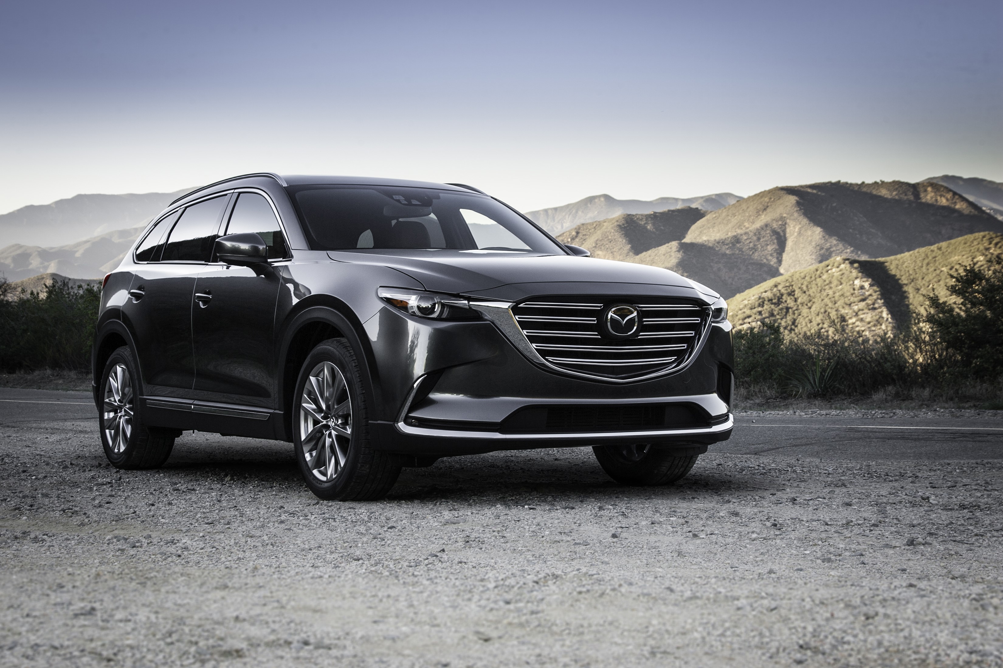 Black Mazda CX-9 parked on gravel road with mountains HD Wallpaper
