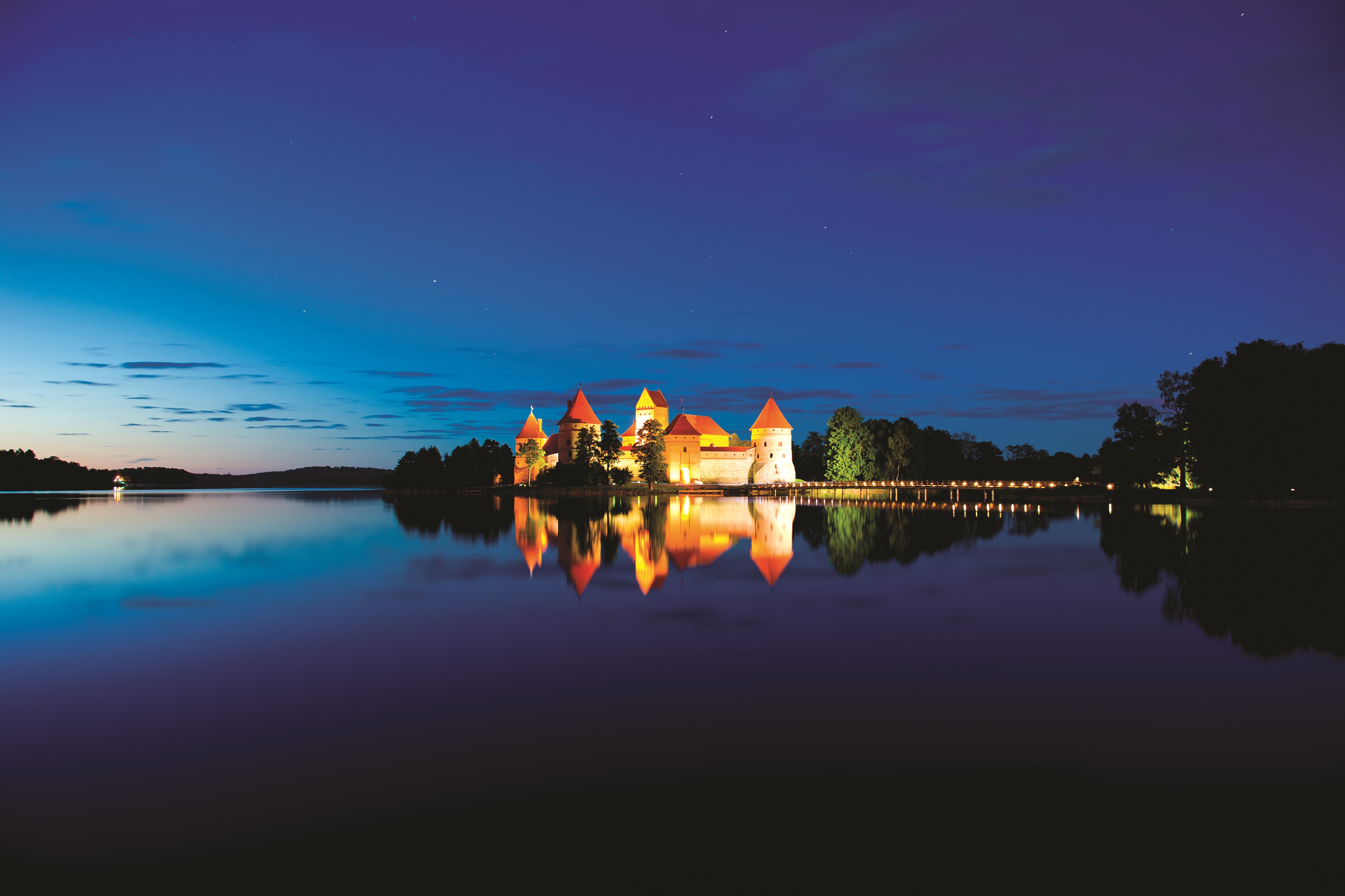 Trakai Island Castle at night reflected in a lake HD Wallpaper