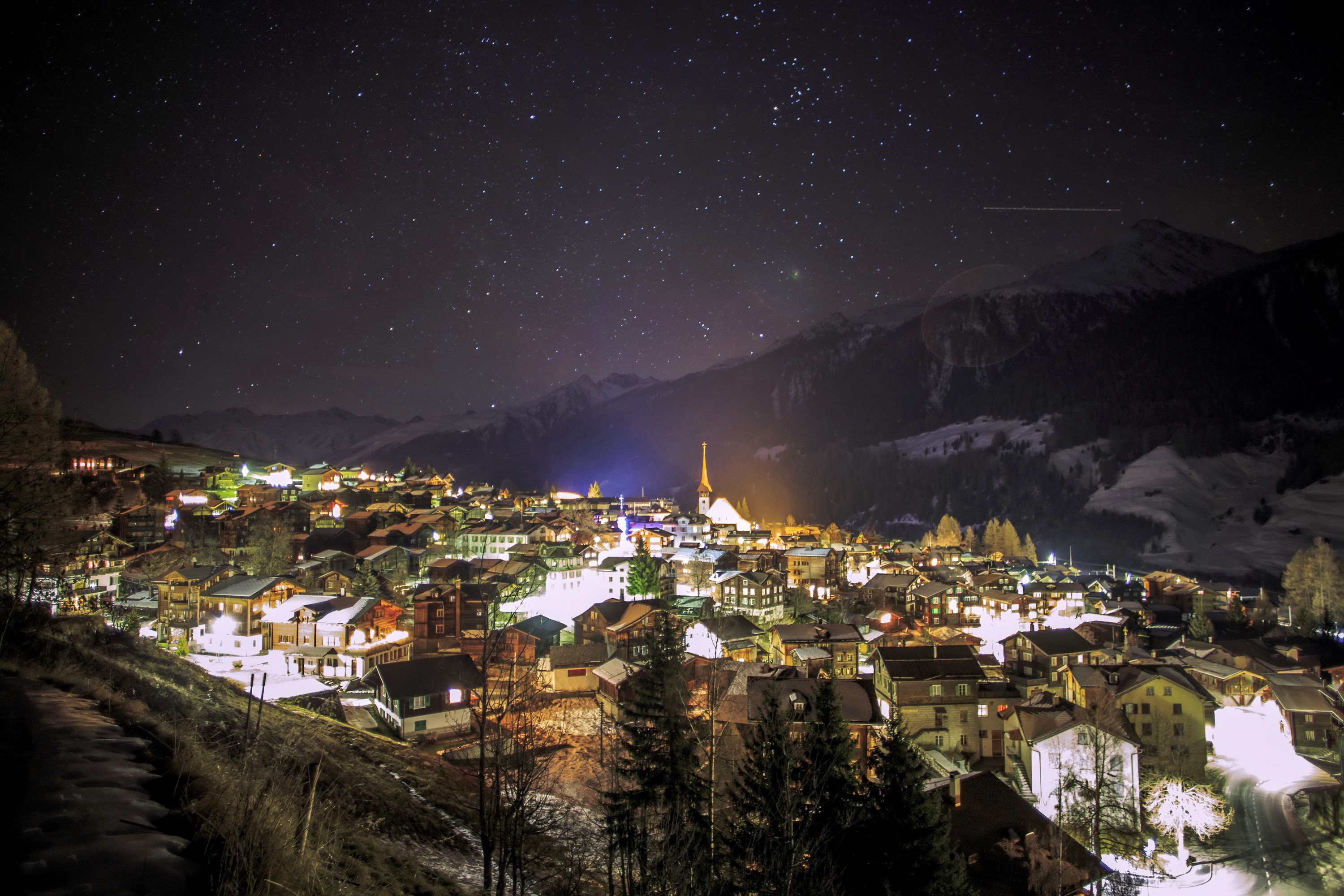 Village at night under starry sky in winter mountains HD Wallpaper