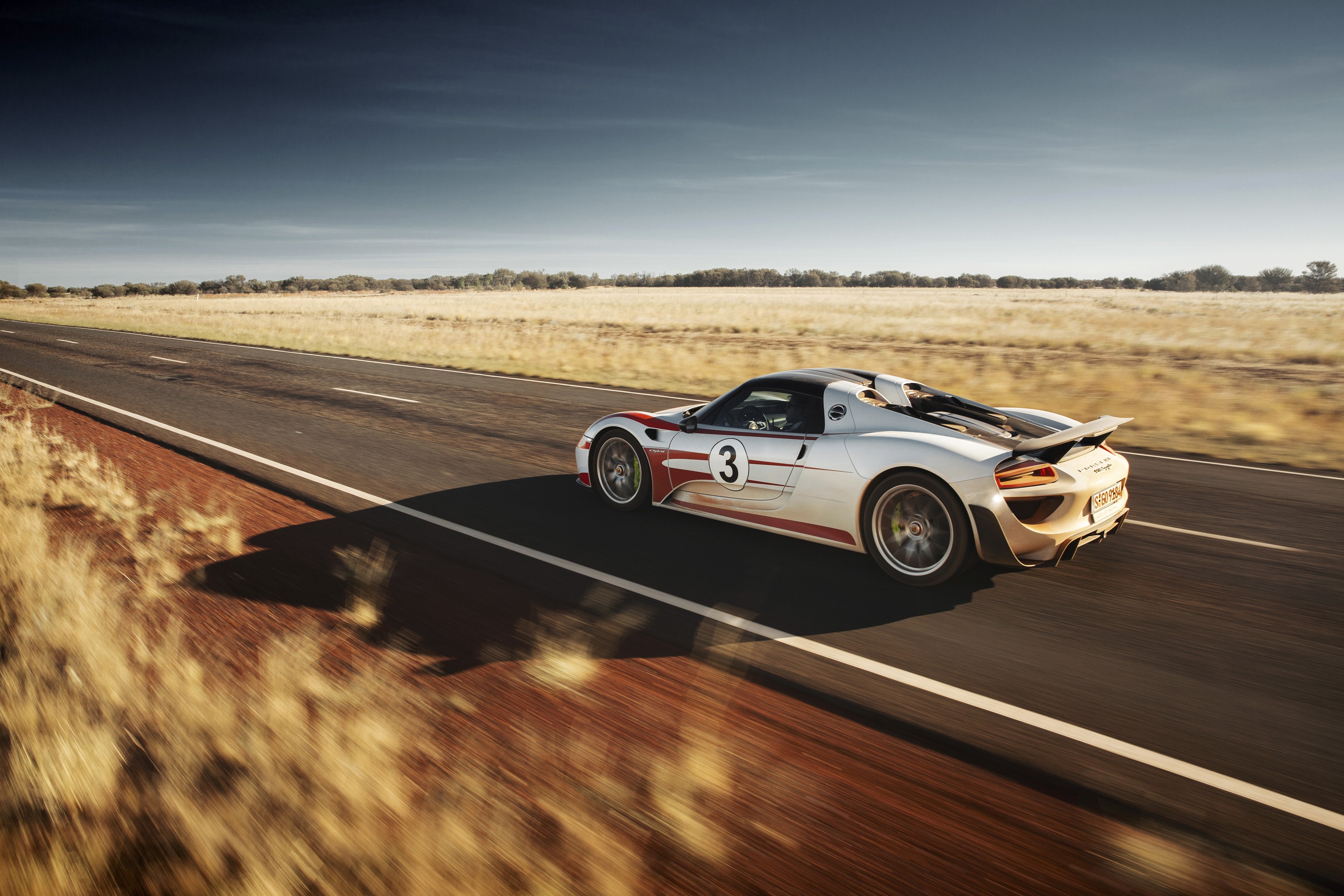Porsche 918 Spyder driving on a road HD Wallpaper