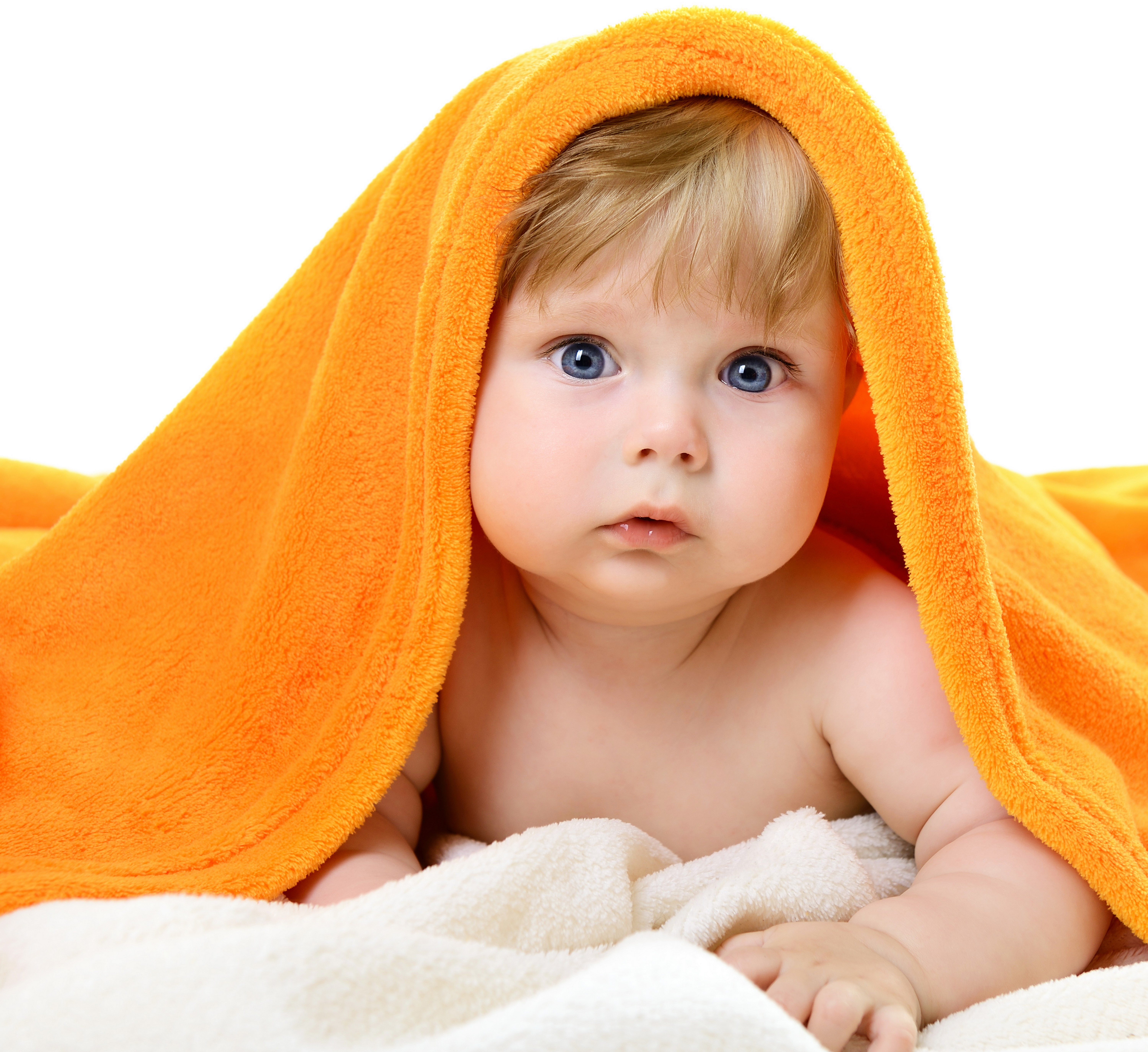 Baby peeking from under an orange towel HD Wallpaper