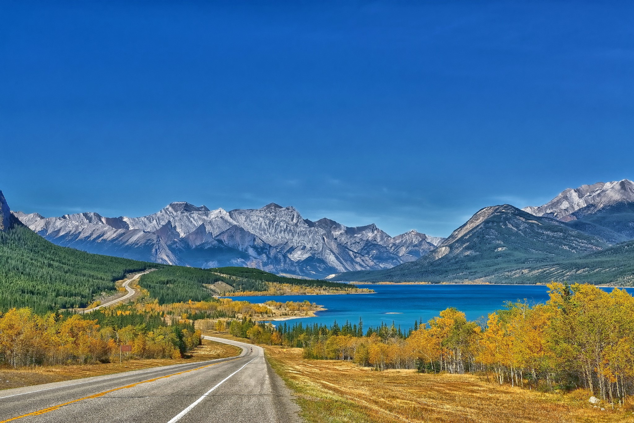 Road leading to mountains and a lake in autumn HD Wallpaper