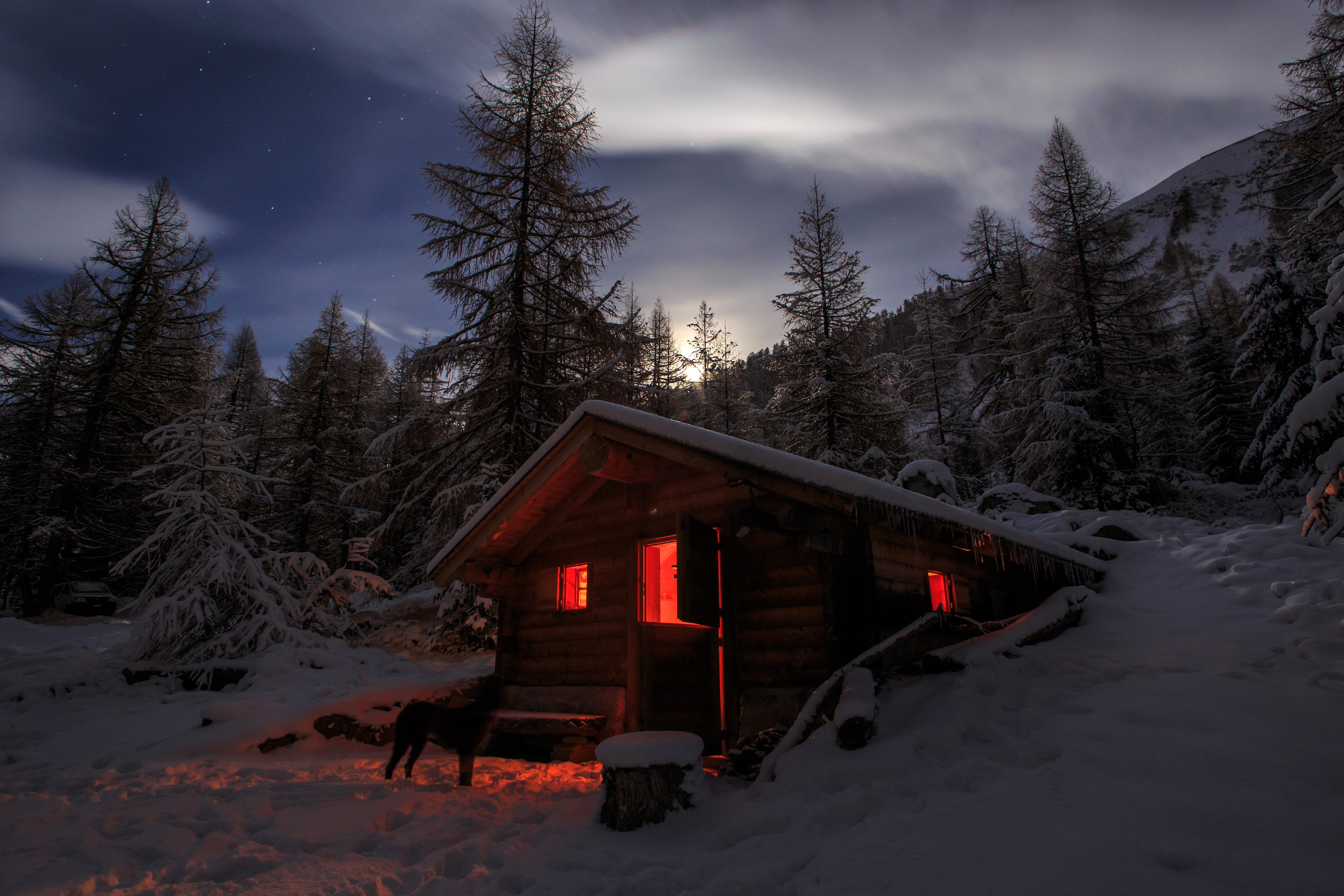Winter night in the Alps with a snowy cabin HD Wallpaper