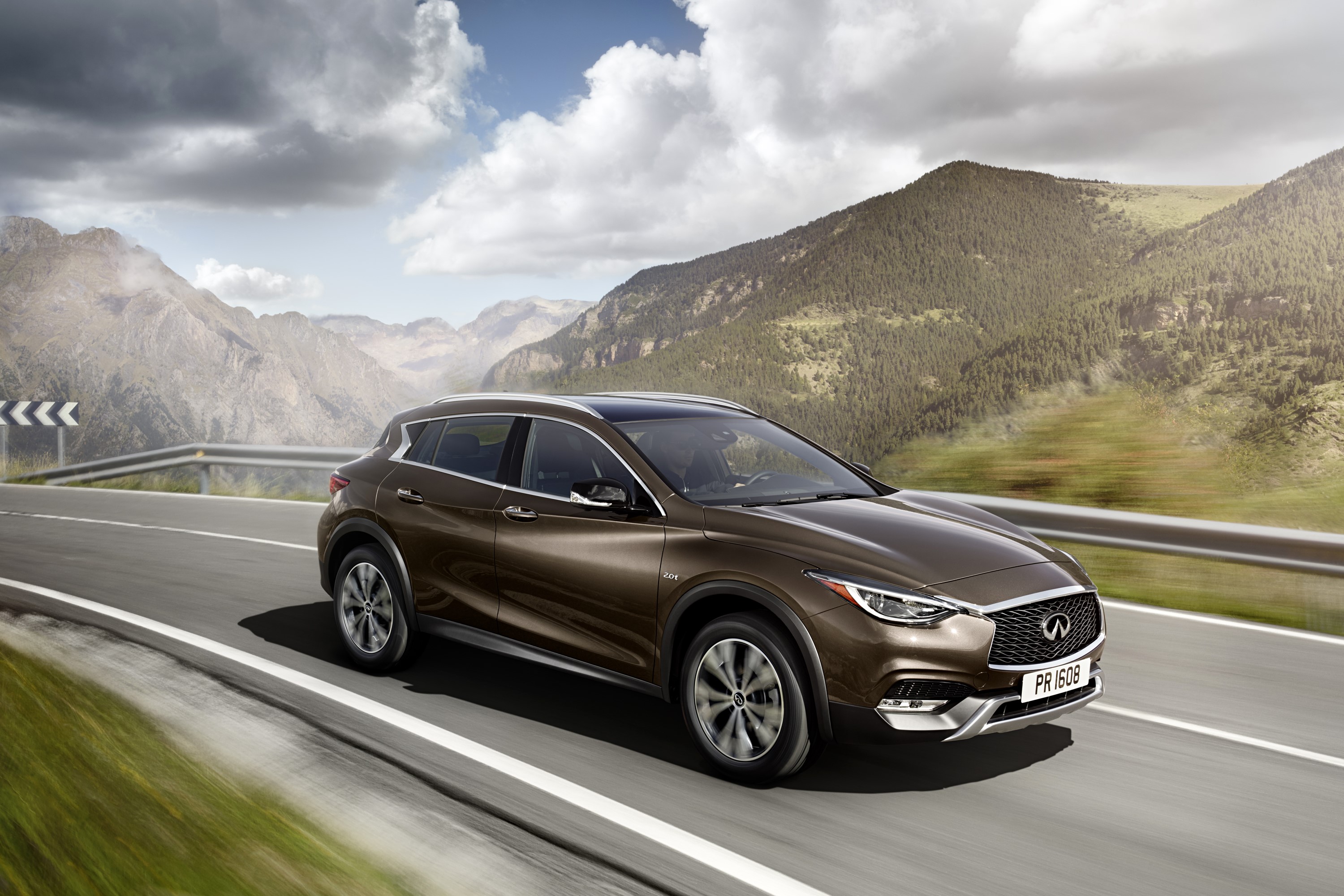2015 Infiniti QX30 driving on a mountain road HD Wallpaper