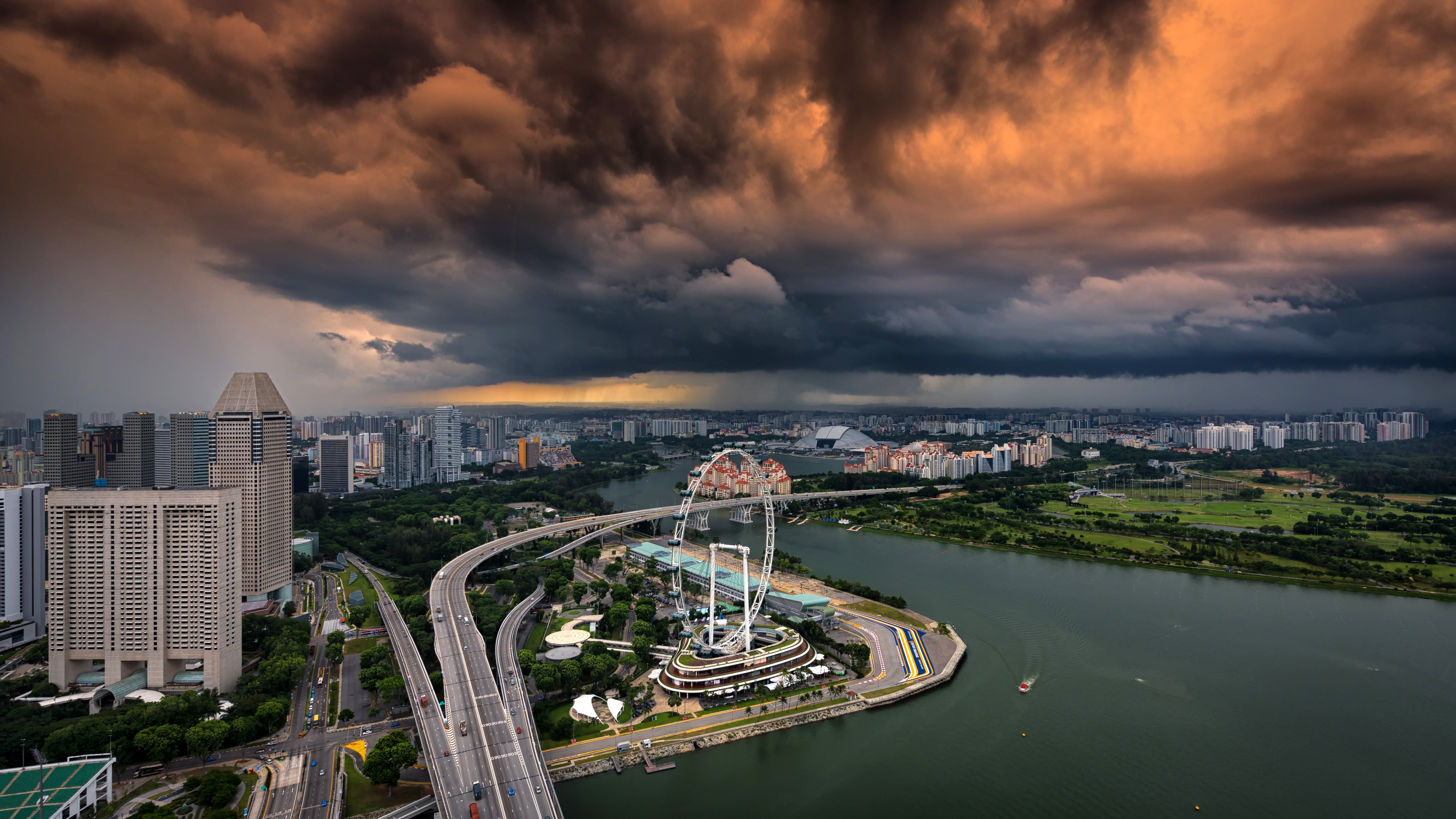 Singapore skyline with storm clouds and Ferris wheel HD Wallpaper