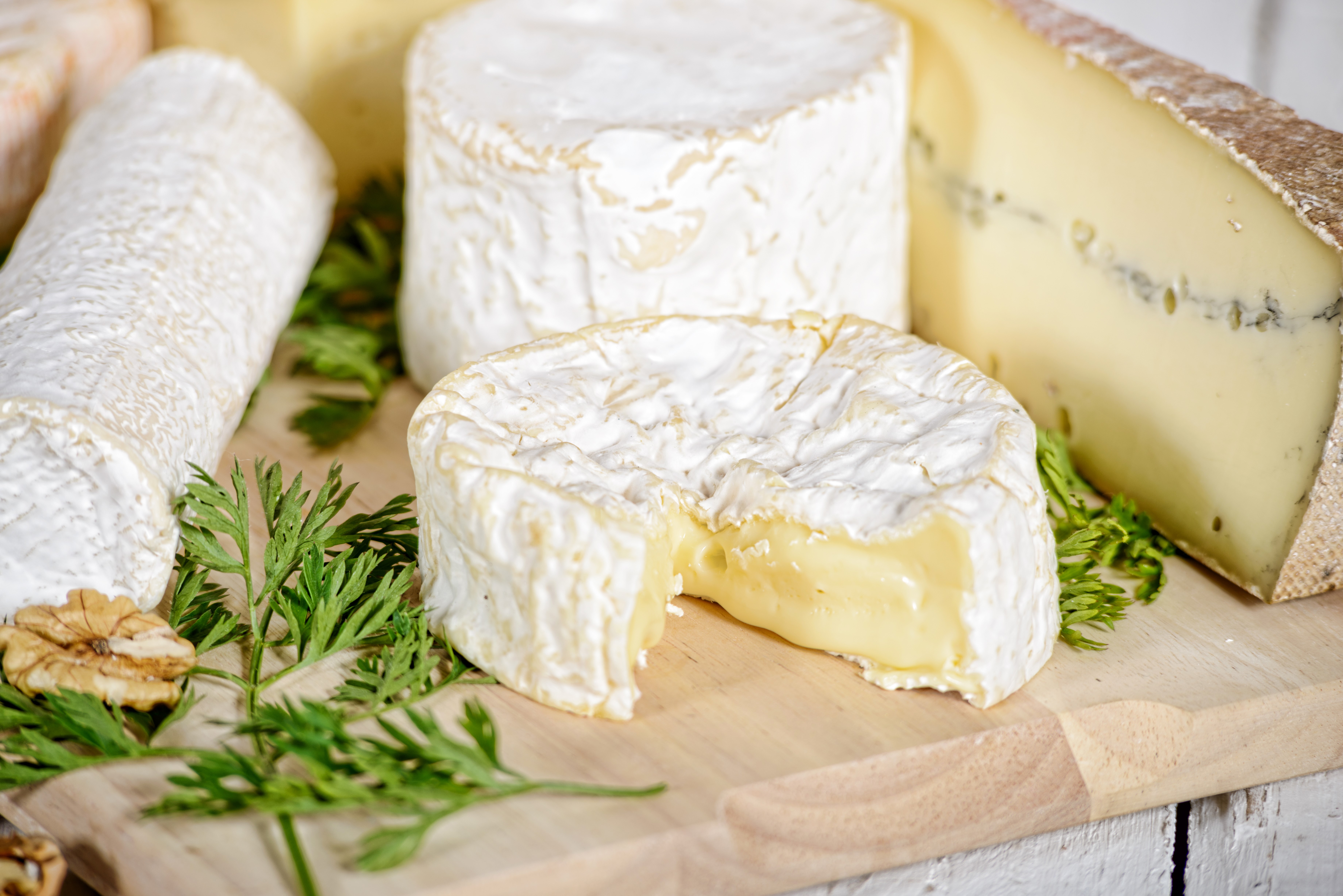 Assortment of Cheeses on a Wooden Board HD Wallpaper