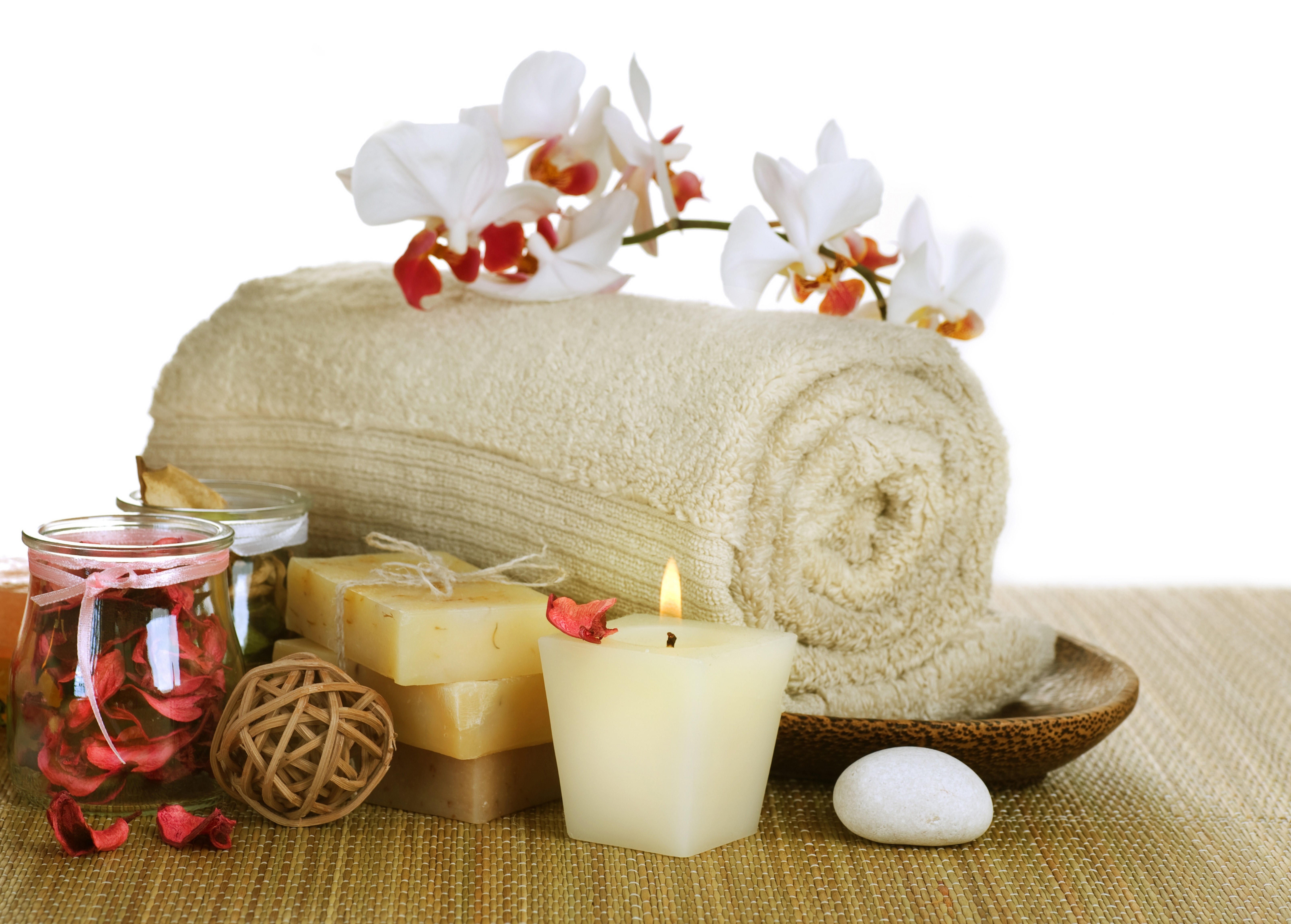 Spa items with orchid, towel, soaps, candle, and stones HD Wallpaper