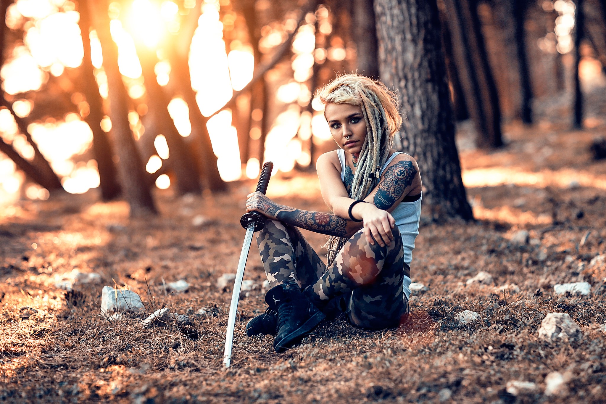 Woman with sword and tattoos in forest HD Wallpaper