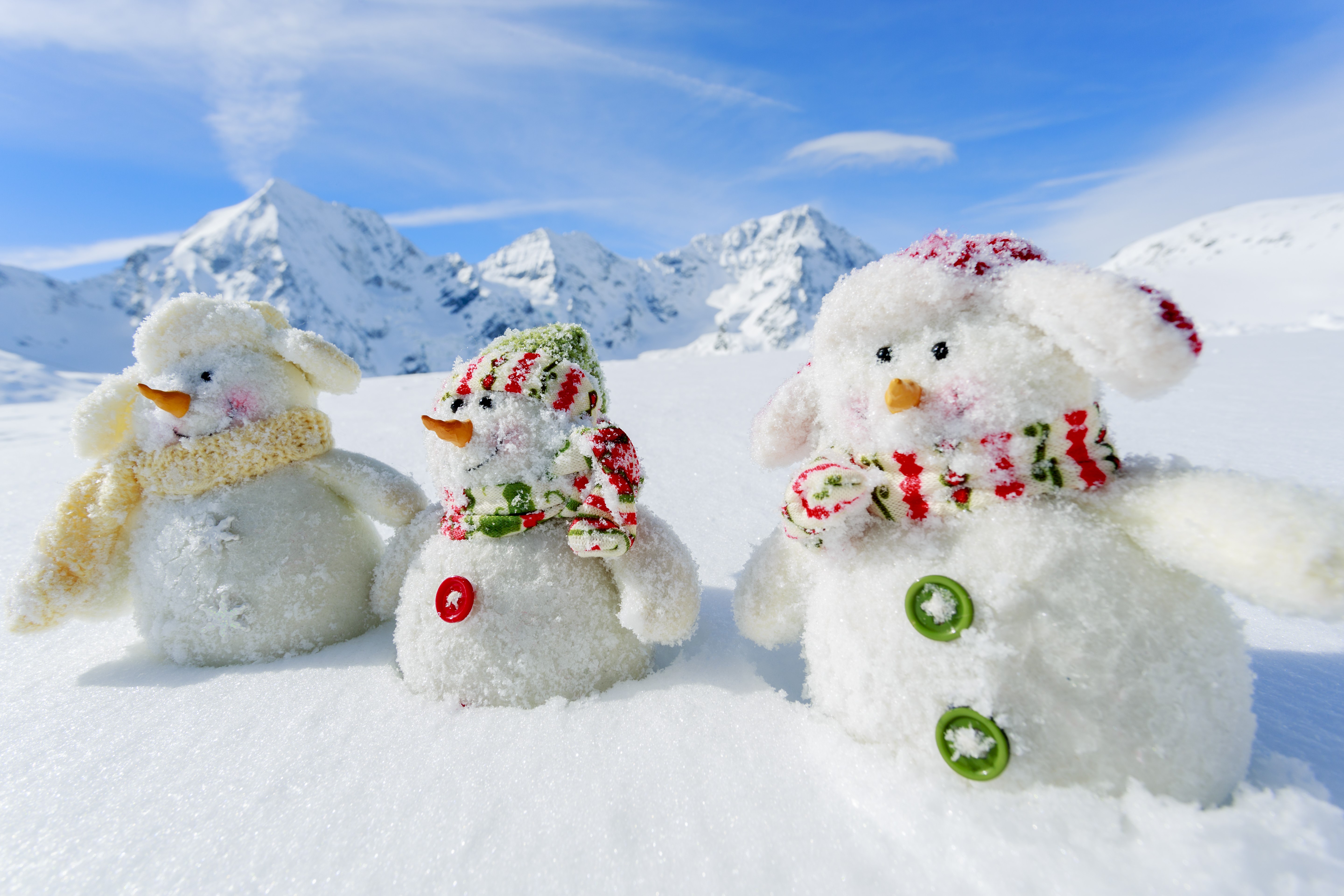 Three snowmen in a snowy mountain landscape HD Wallpaper